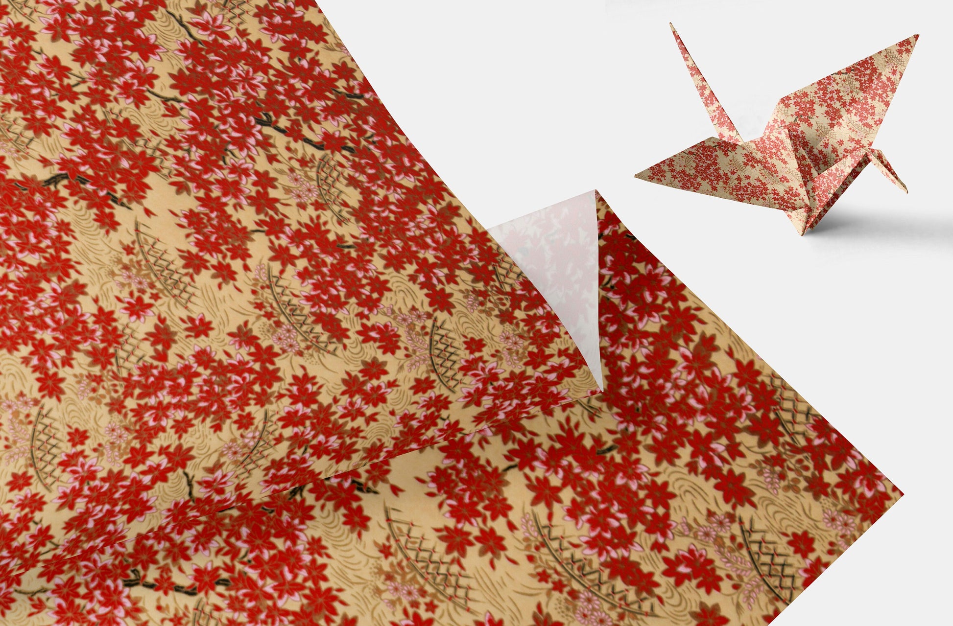 Red and gold floral-patterned paper with a folded paper crane on a white background