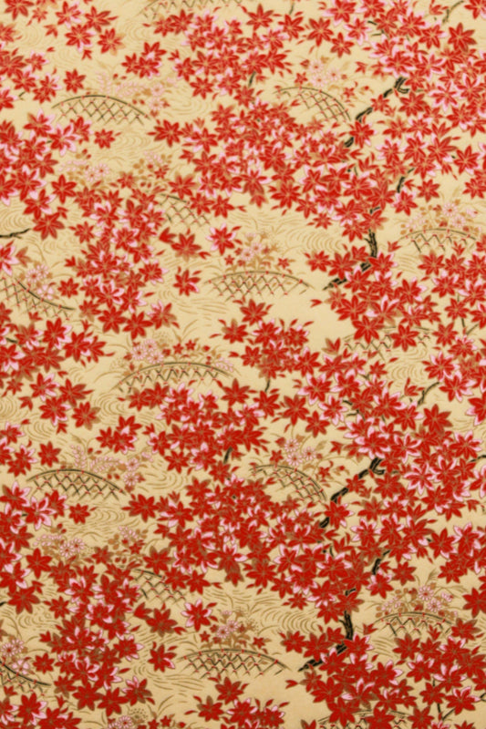 Floral patterned fabric with red flowers on a beige background