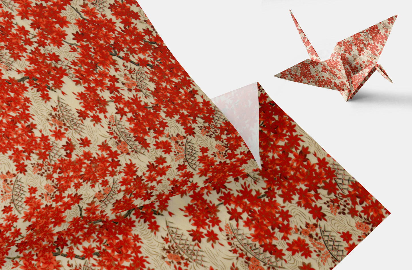 Red floral-patterned chiyogami paper with a folded paper crane on a white background
