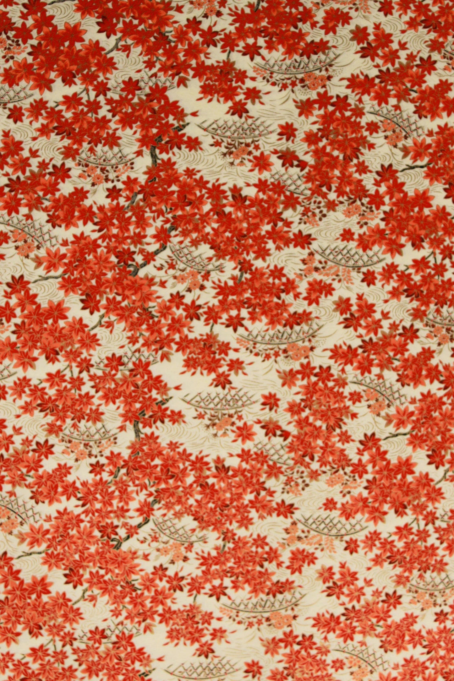 Patterned chiyogami paper with red floral design on a beige background
