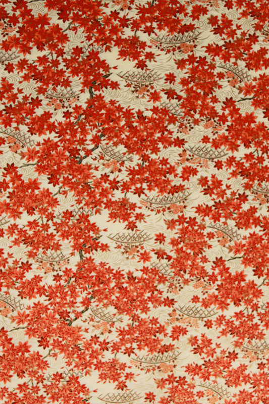 Patterned chiyogami paper with red floral design on a beige background