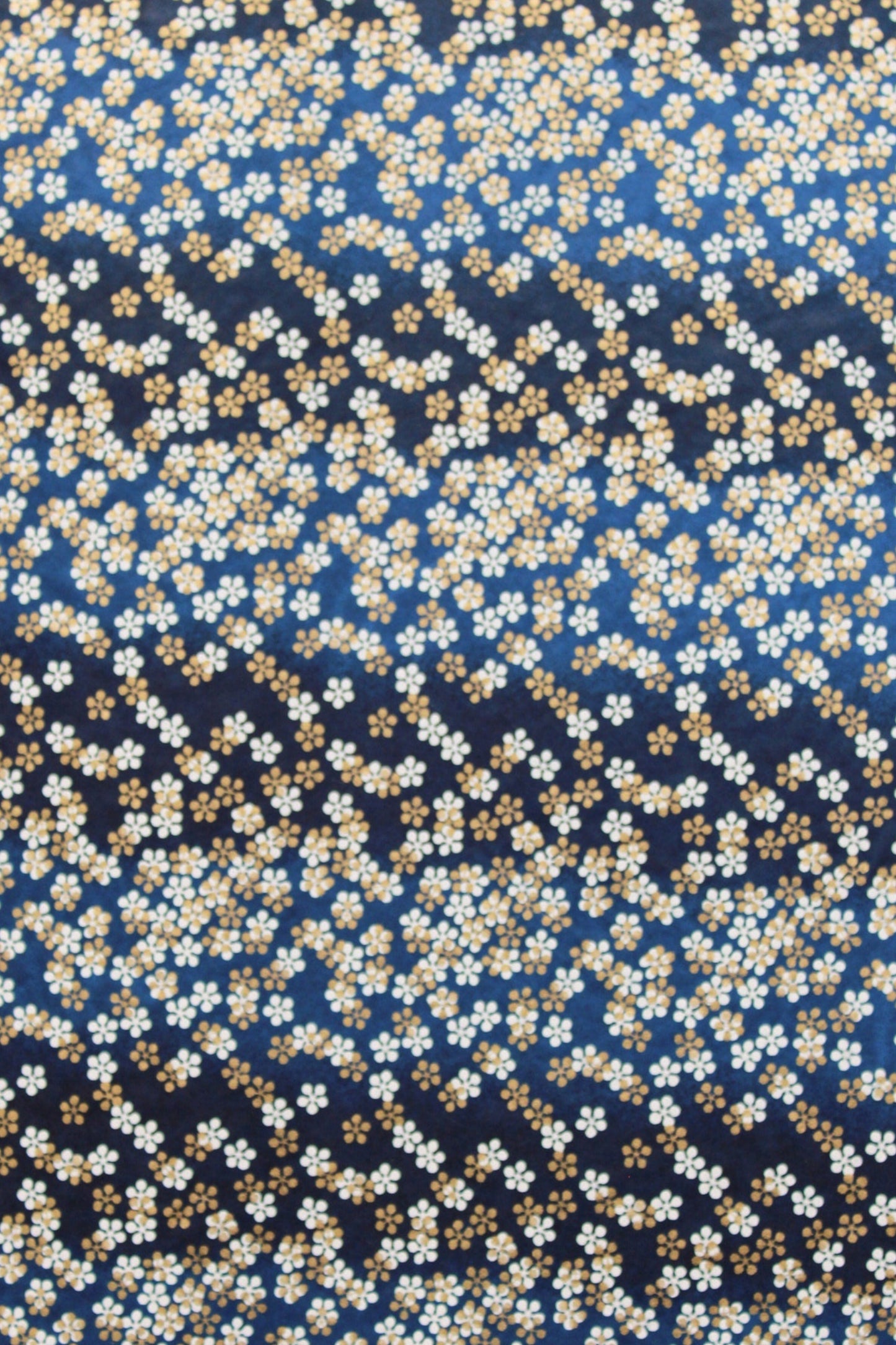 Patterned  chiyogami paper with small white flowers on a dark blue background