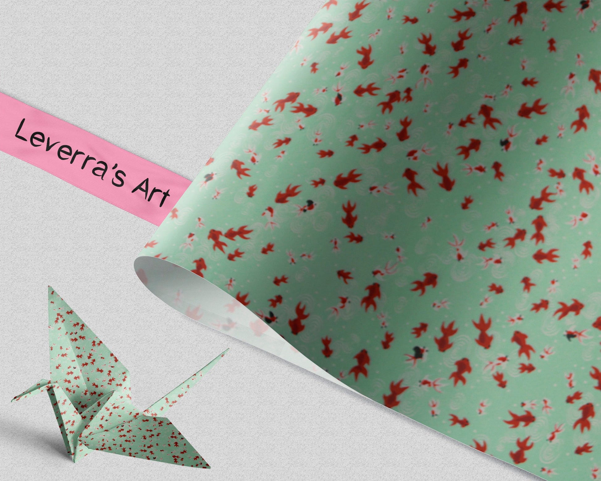 Green paper with red fish pattern and a folded green paper crane on a light gray background, featuring 'Leverra's Art' label.