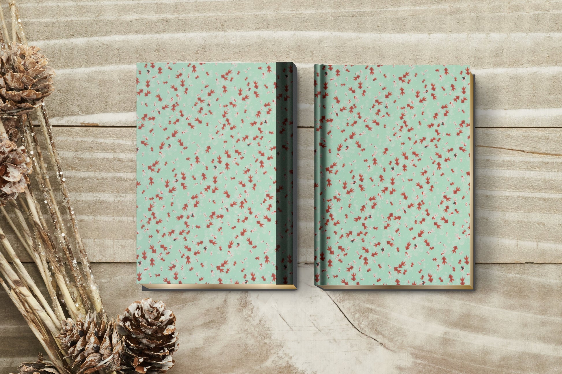 Two notebooks with a floral pattern on a wooden surface with decorative elements.