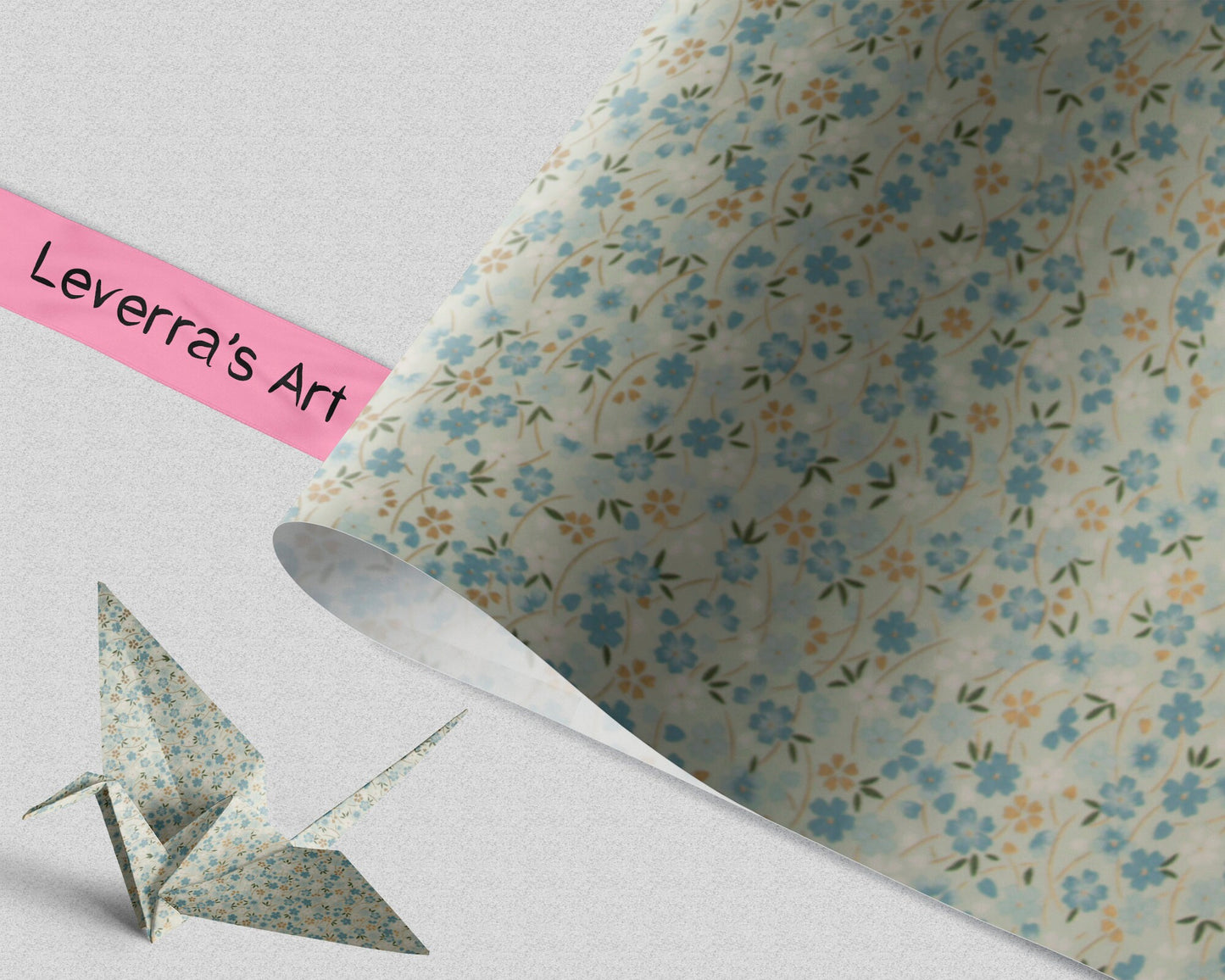 Floral-patterned chiyogami paper with an origami crane and a pink strip labeled 'Leverra's Art' on a light background.