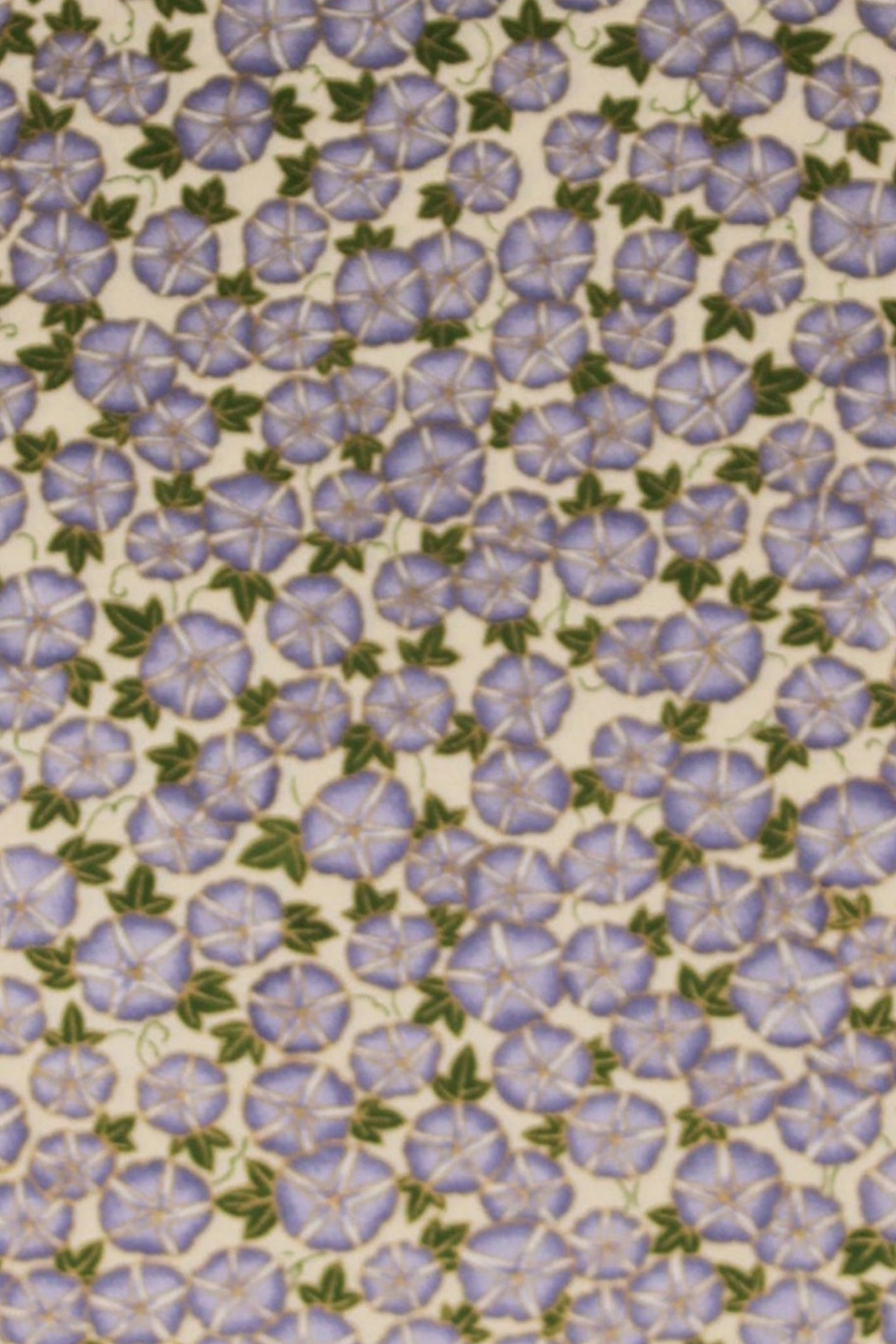 Patterned chiyogami paper with small purple flowers on a beige background