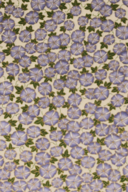 Patterned chiyogami paper with small purple flowers on a beige background