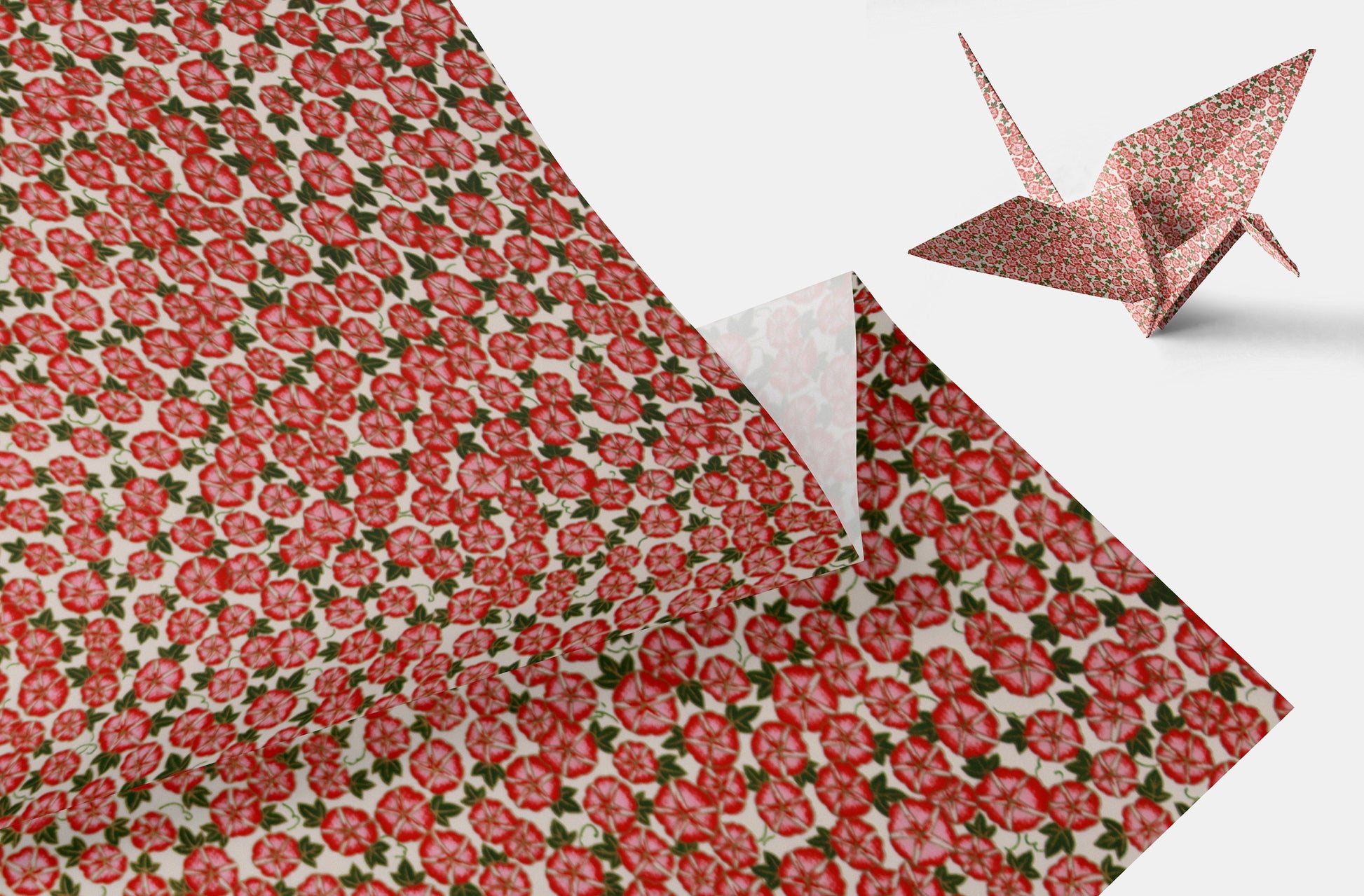 Floral-patterned chiyogami paper with a pink origami crane on a white background