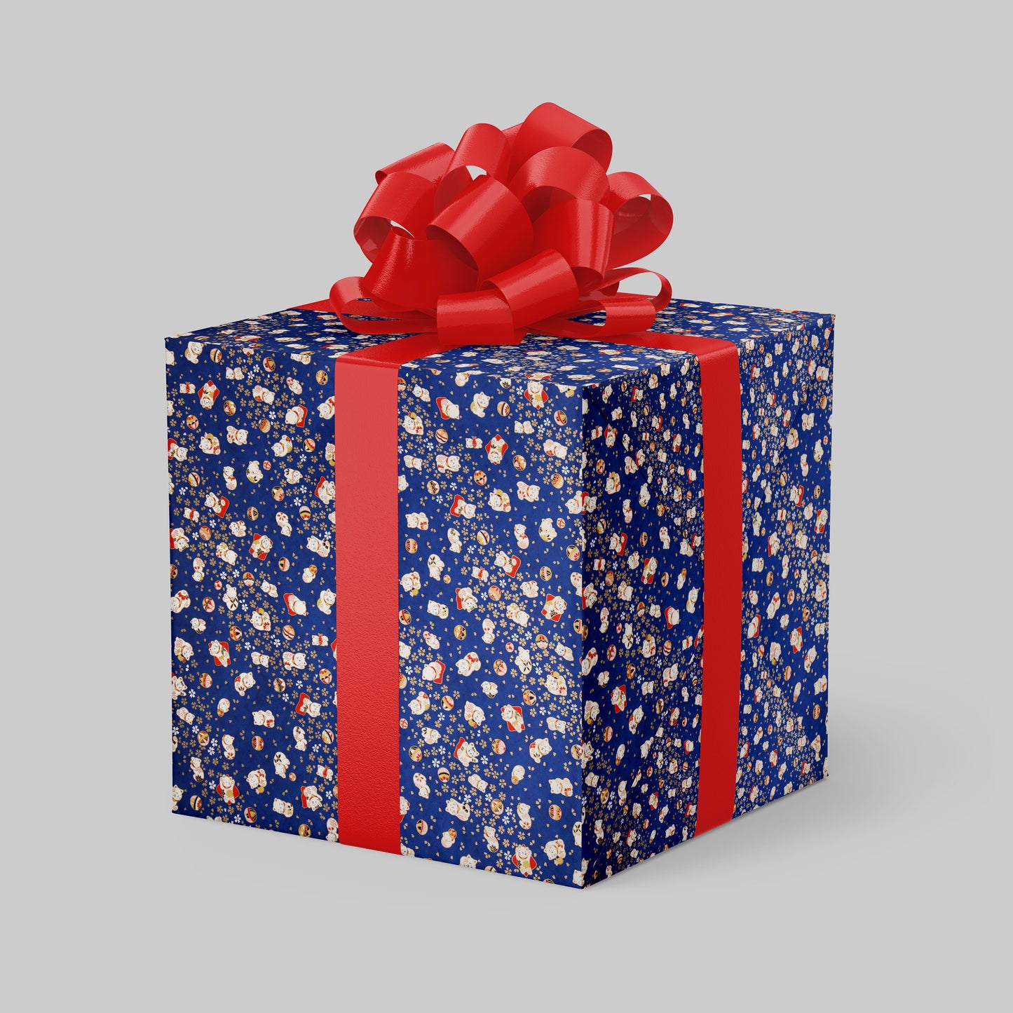Blue gift box wrapped with chiyogami paper with a red ribbon and bow on a gray background