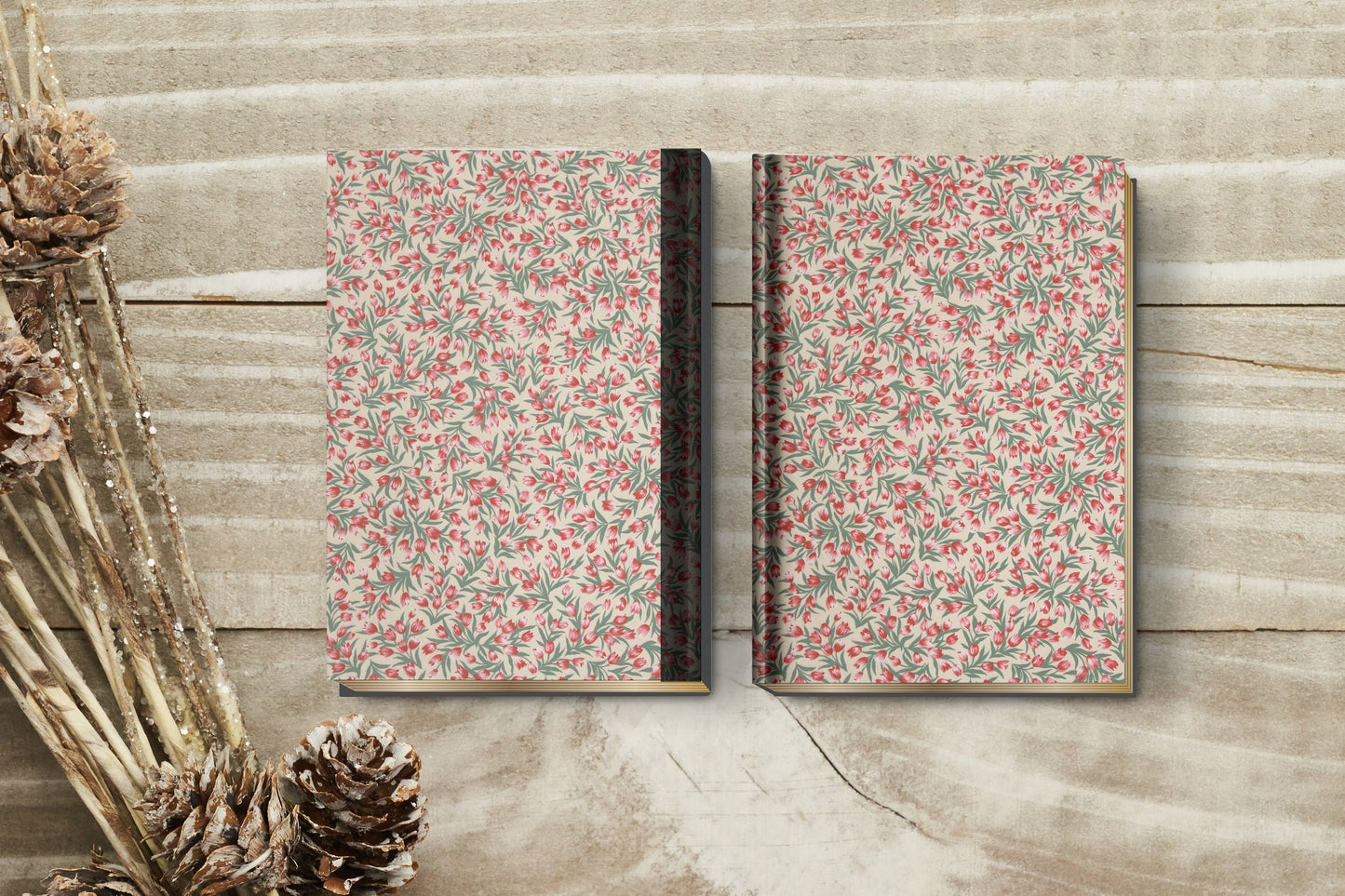 Two floral-patterned books on a wooden surface 