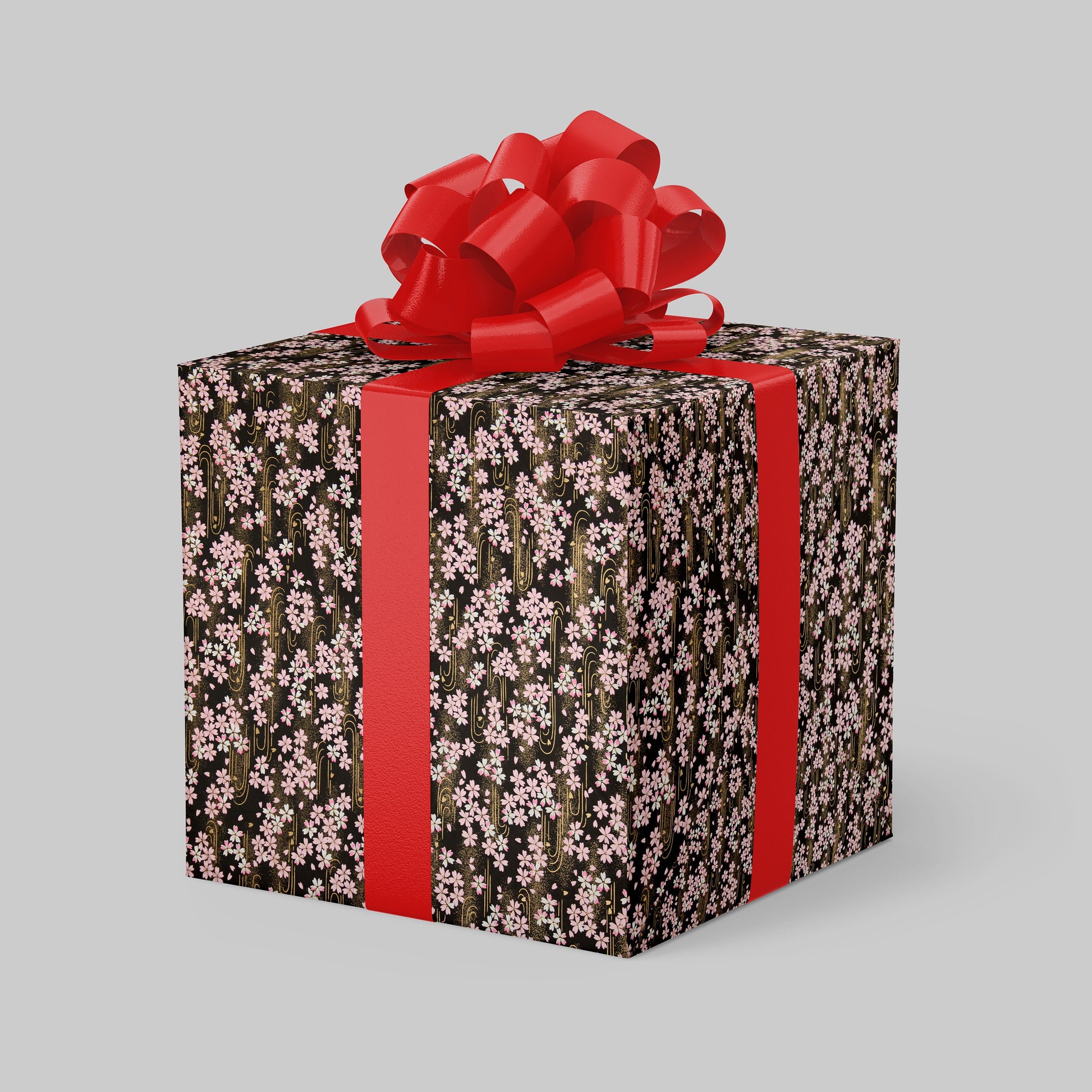 Gift box with floral pattern and red ribbon on a gray background