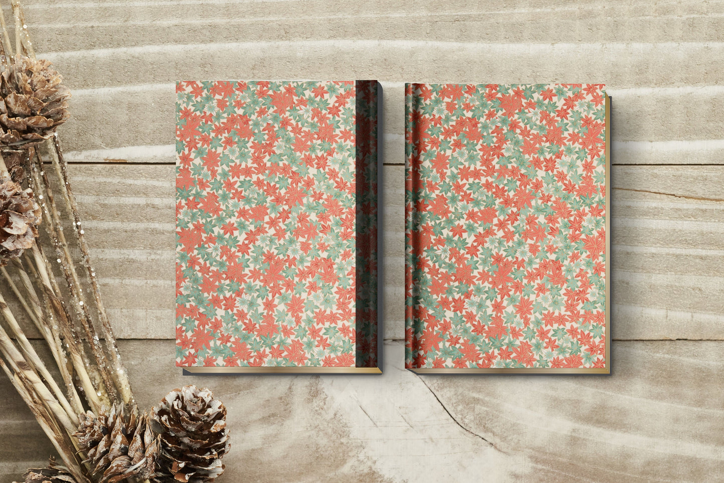 Two patterned books made with chiyogami paper in a bookbinding project on a wooden surface with decorative elements.