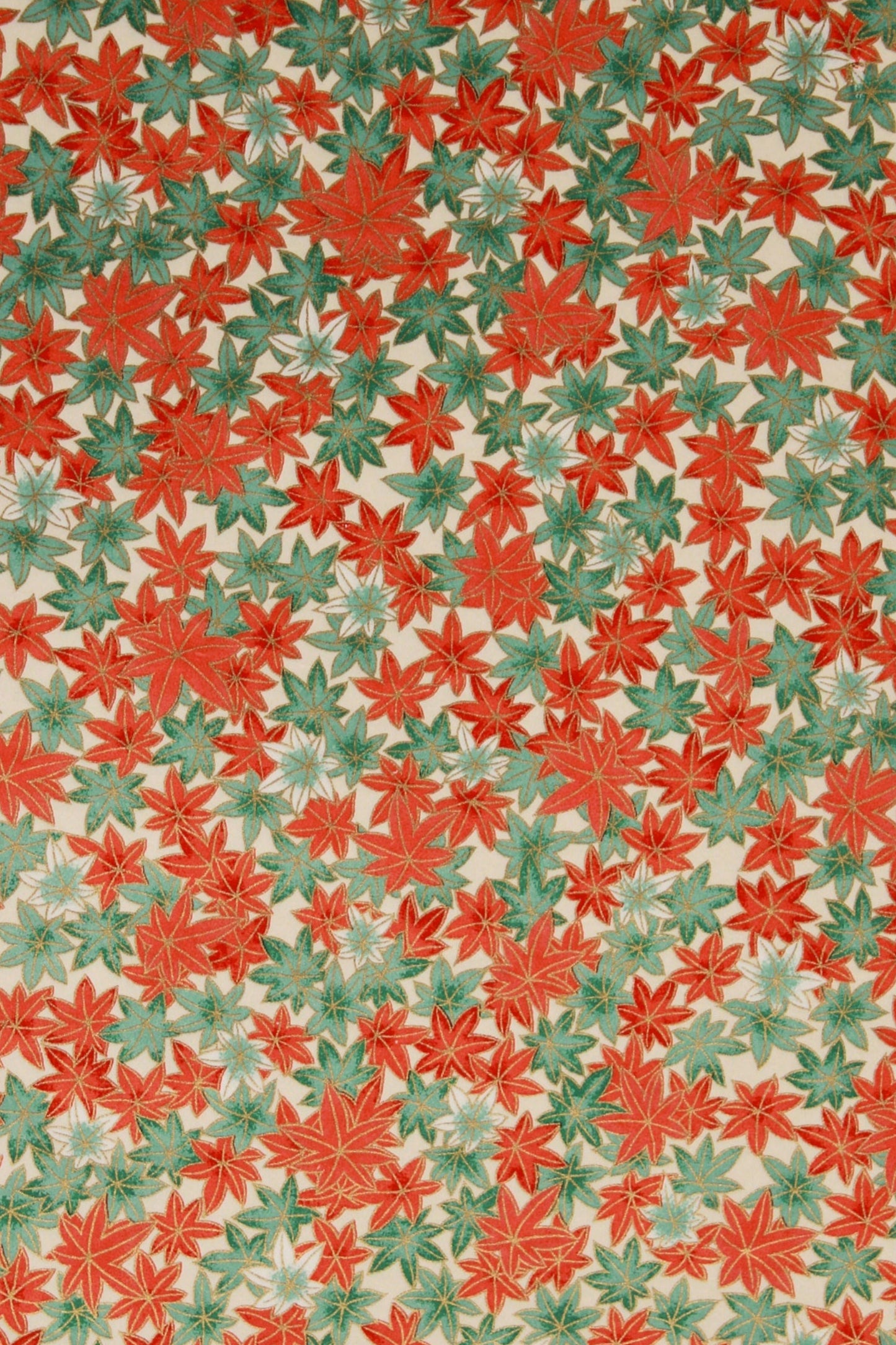 Patterned chiyogami paper with red and green leaves on a beige background