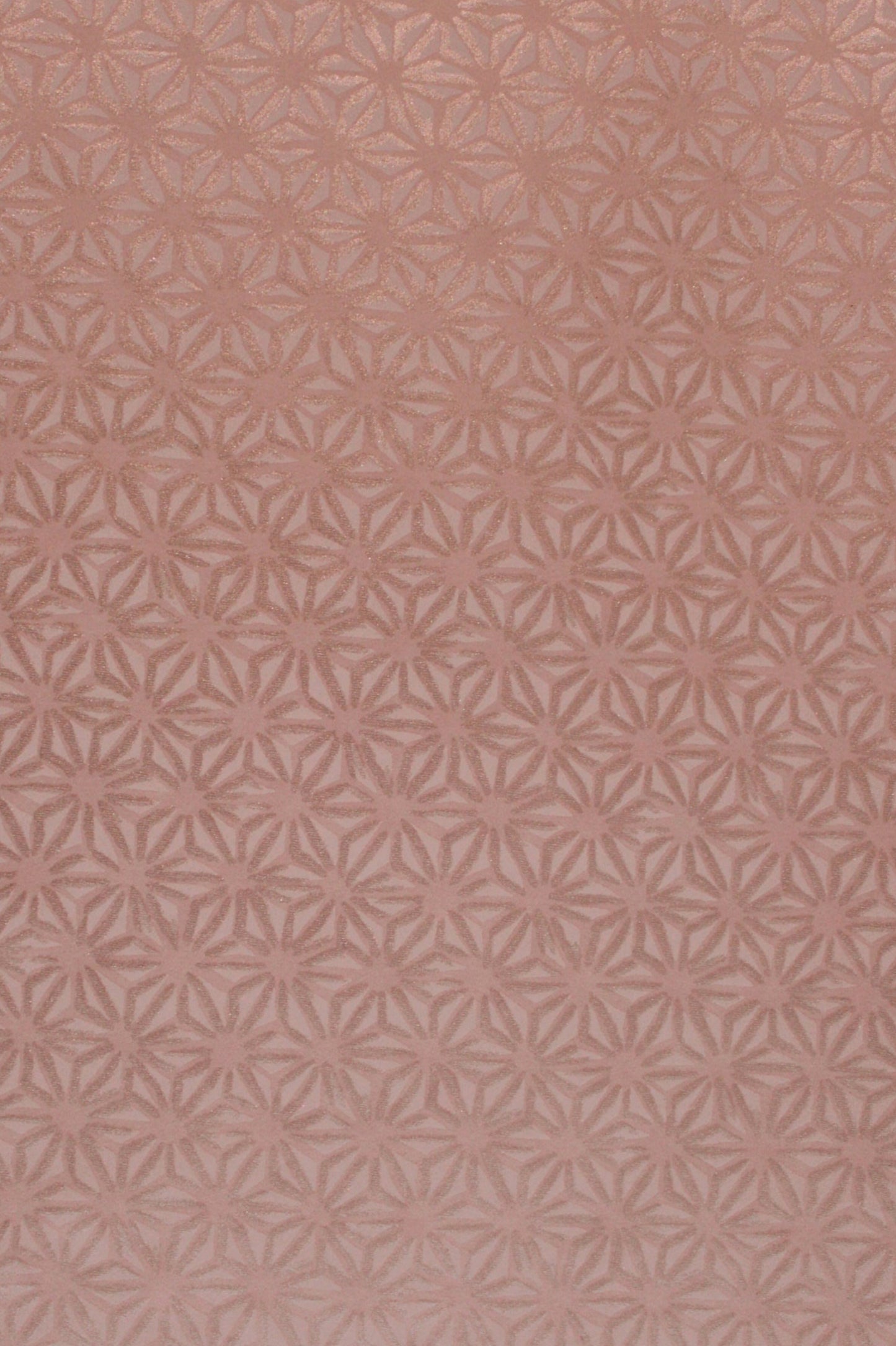 Patterned chiyogami paper with a geometric design on a pink background