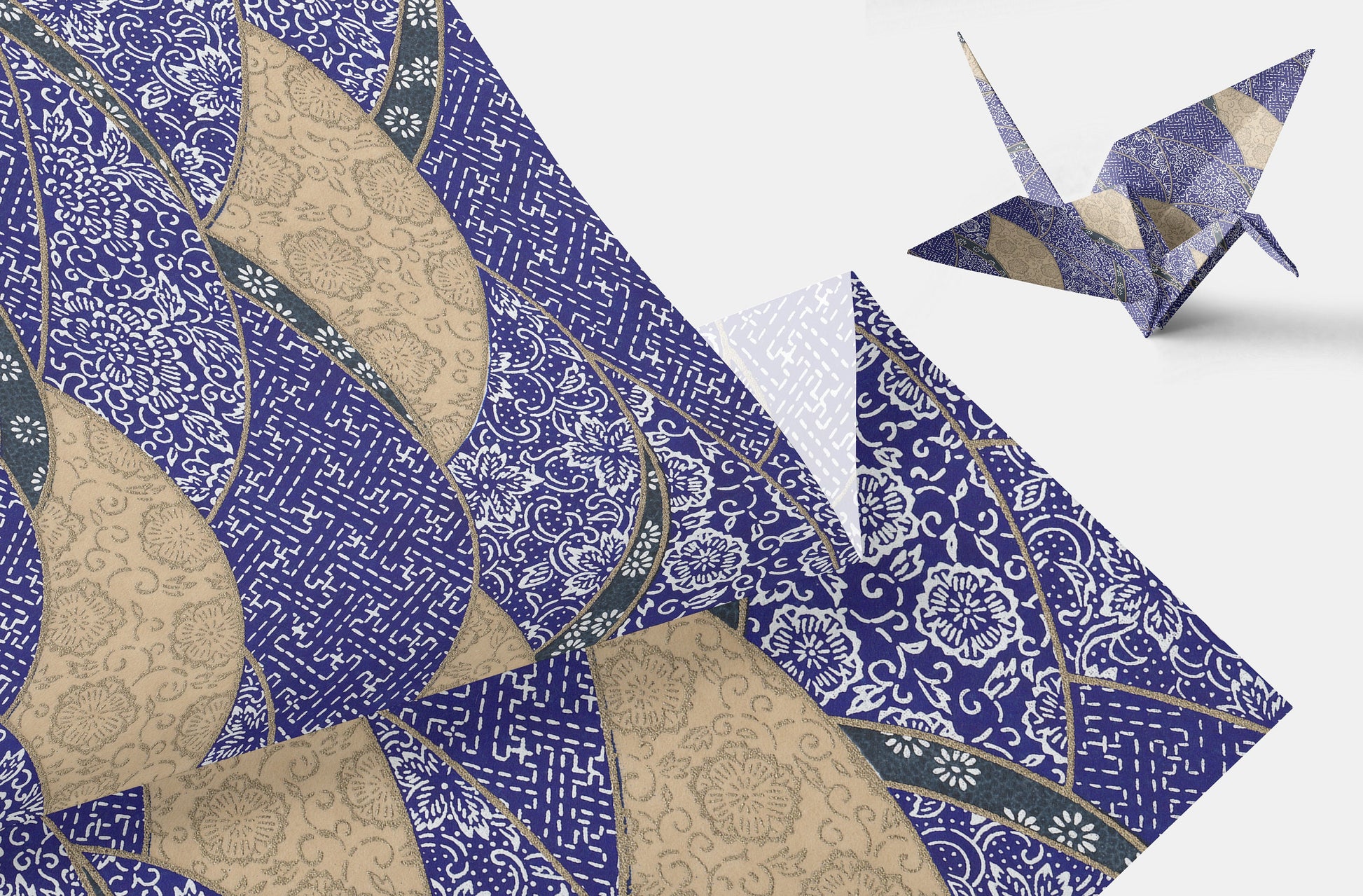 Decorative  chiyogami paper with intricate patterns and a folded paper crane on a white background