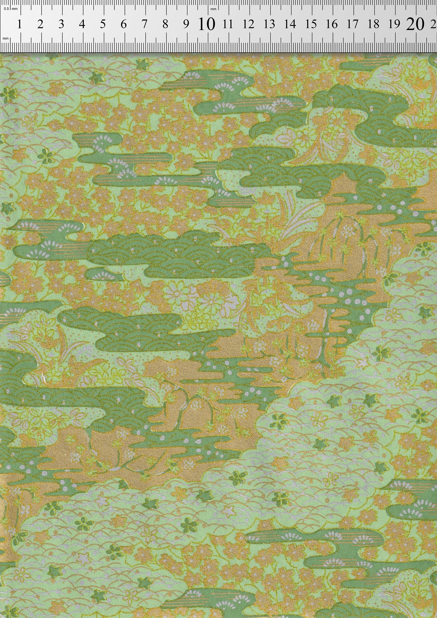 Chiyogami paper with green and orange pattern, measured against a ruler