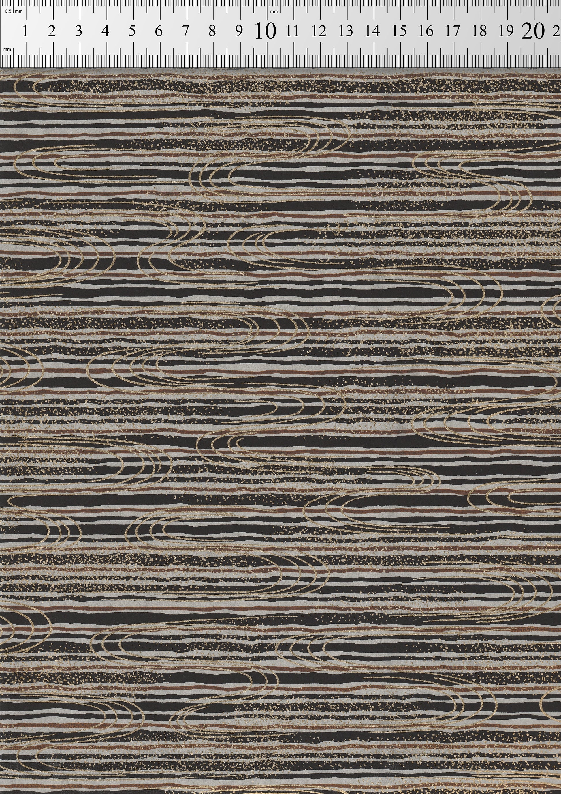 Textured chiyogami paper with wavy line pattern on a ruler background