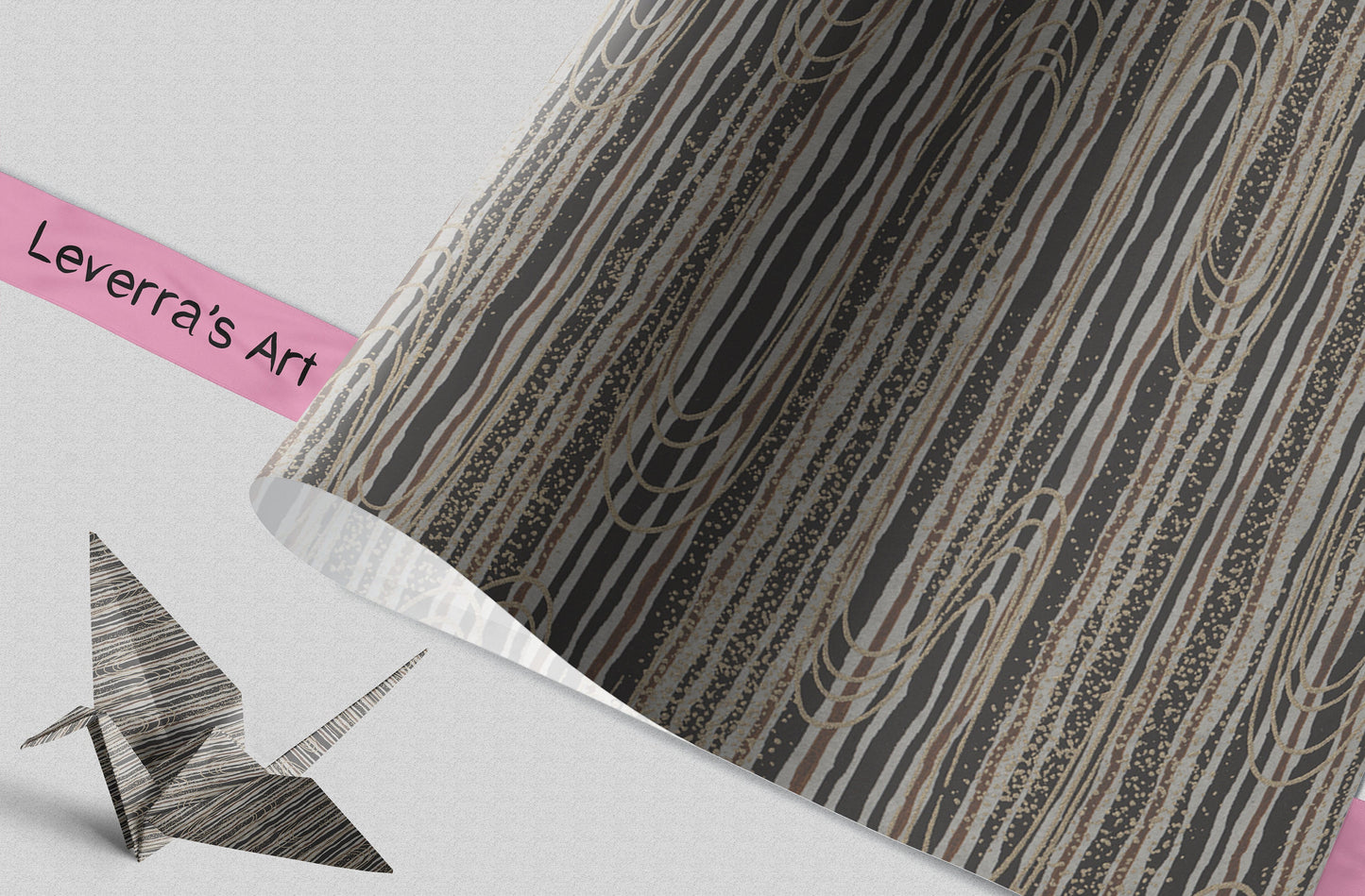 Patterned chiyogami paper with wavy line pattern in brown and beige tones and 'Leverra's Art' label and a folded paper crane.