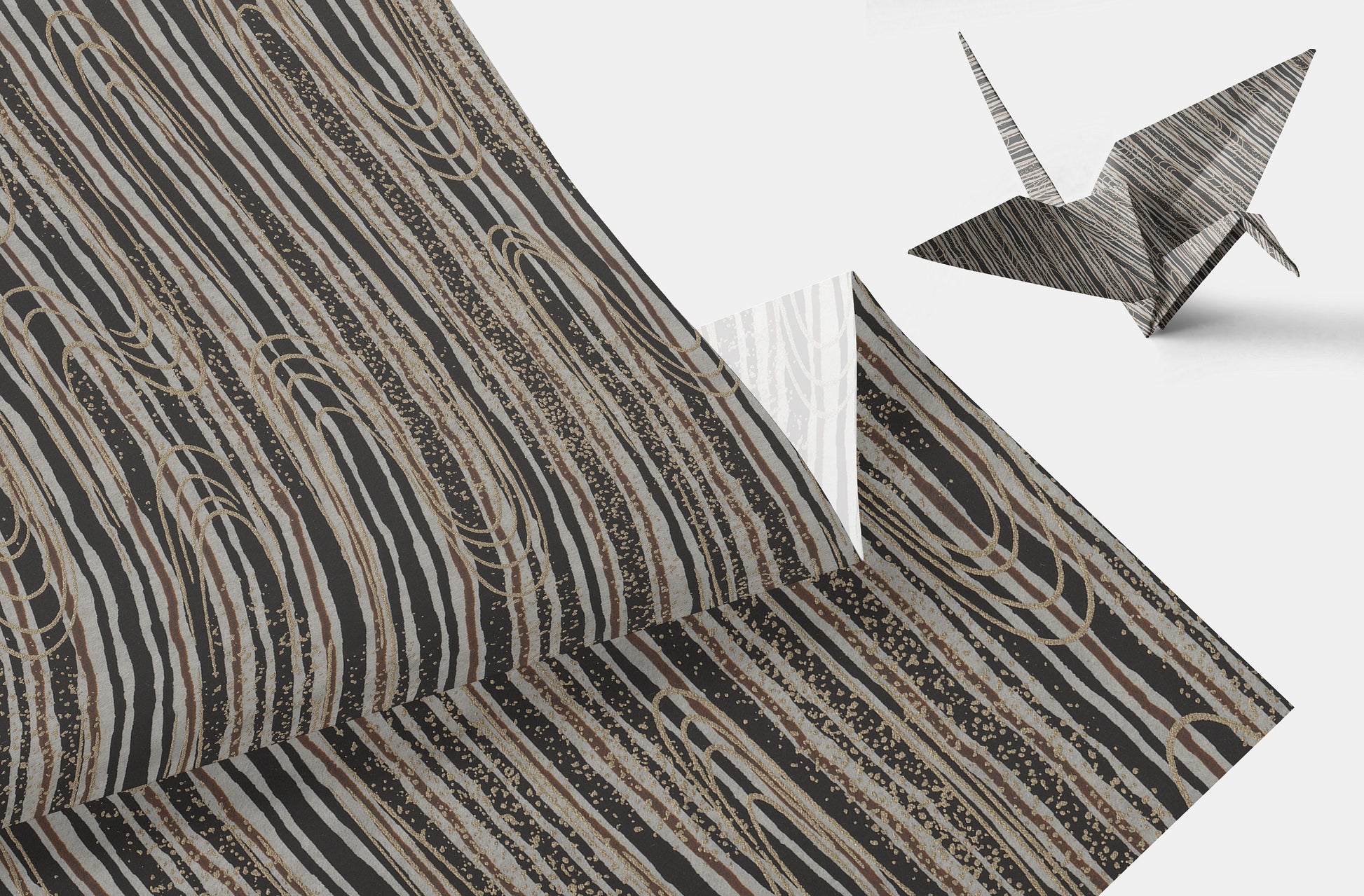 Chiyogami paper with geometric pattern wavy line pattern in brown and beige tone and origami crane on a white background