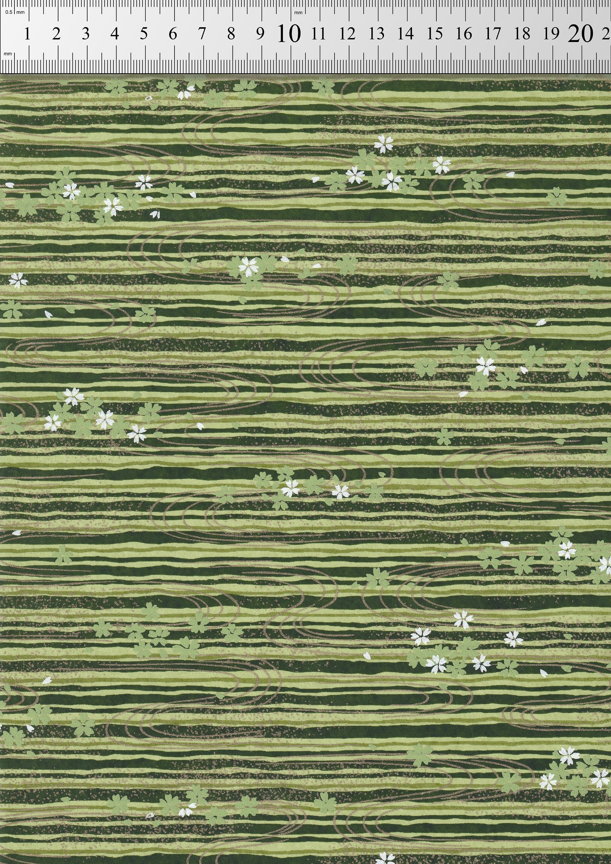 Green striped chiyogami paper with small white flowers pattern, measured against a ruler.