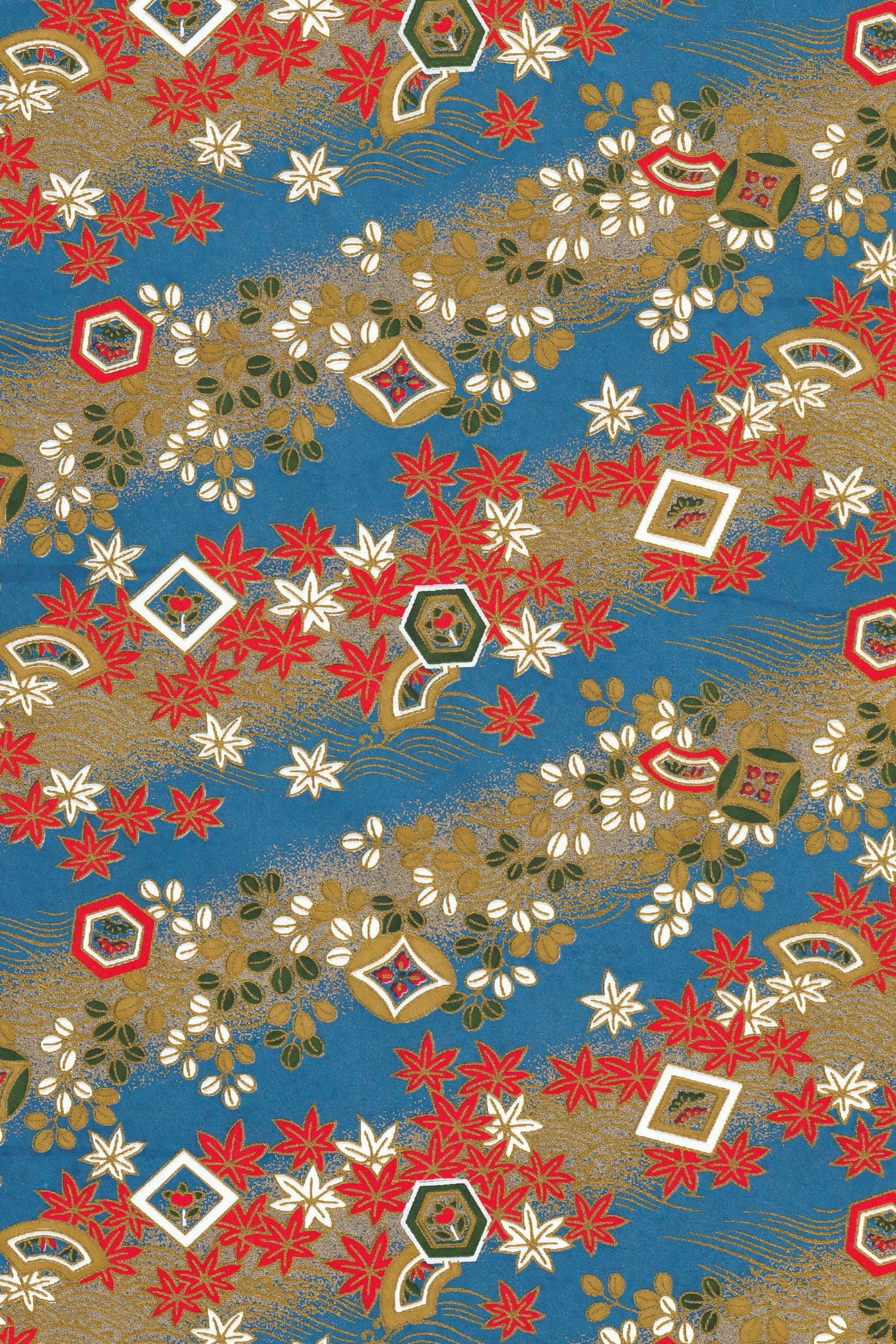 Decorative chiyogami paper pattern with red, white, and gold elements on a blue background