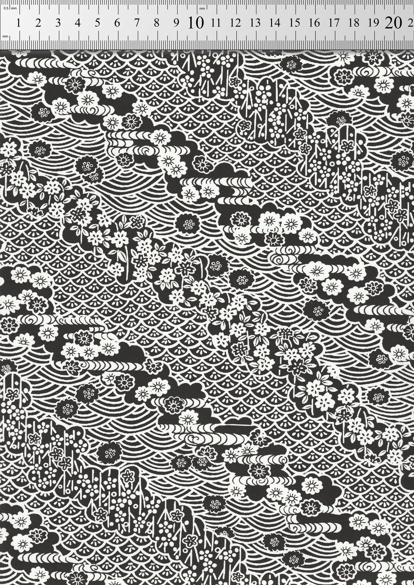 Black and white patterned  chiyogami paper with geometric designs on a black background