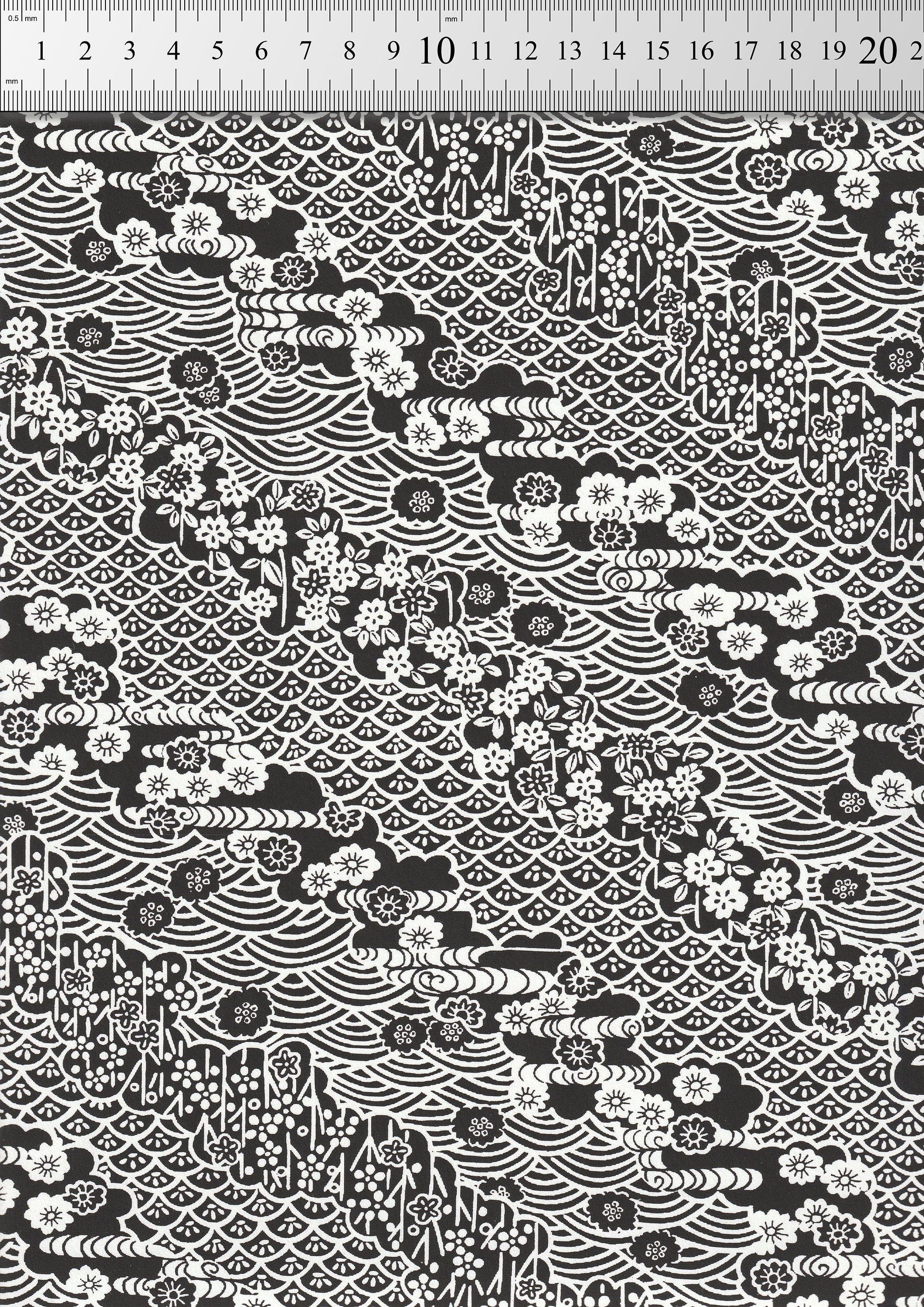 Black and white patterned  chiyogami paper with geometric designs on a black background