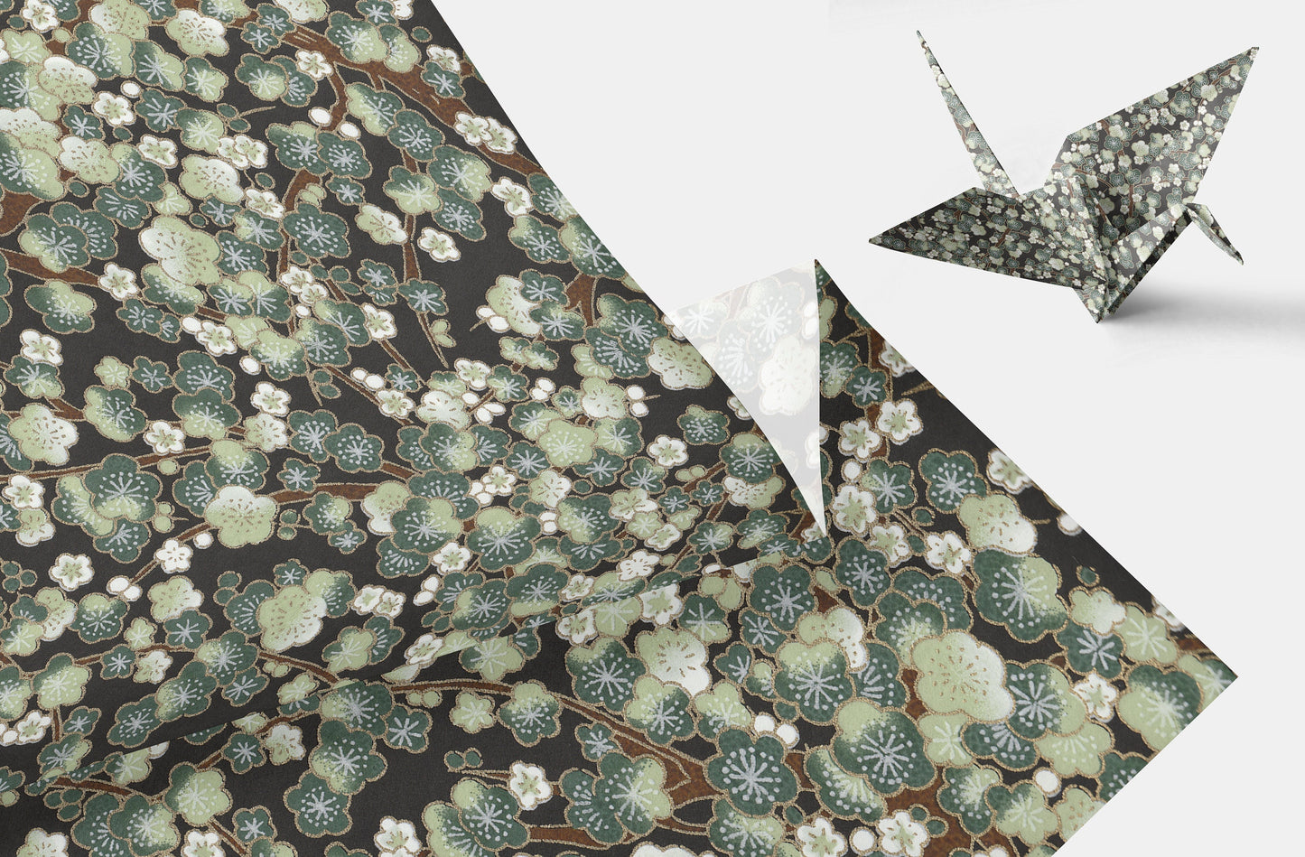 Decorative chiyogami paper with floral pattern and a folded paper crane on a white background