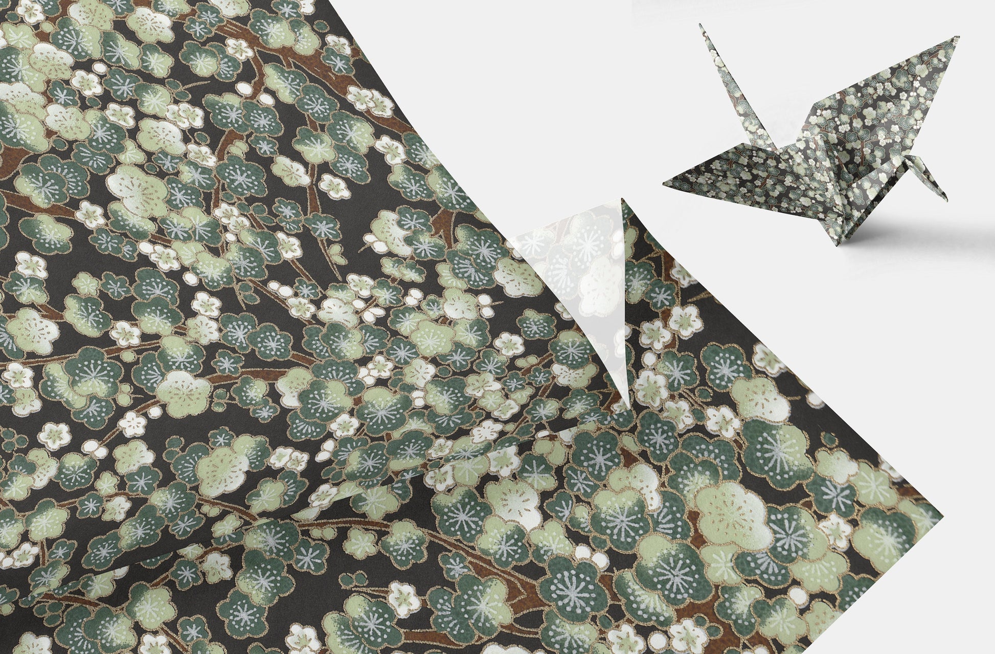 Decorative chiyogami paper with floral pattern and a folded paper crane on a white background