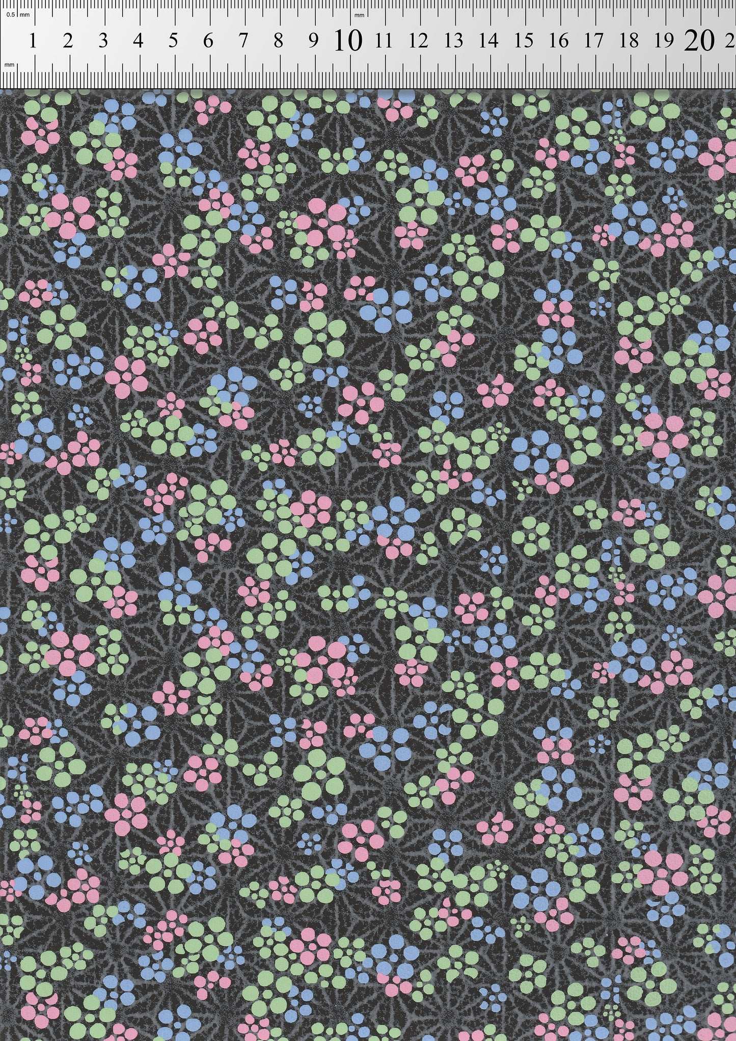 Floral pattern  chiyogami paper with pink, blue, and green flowers on a black background.