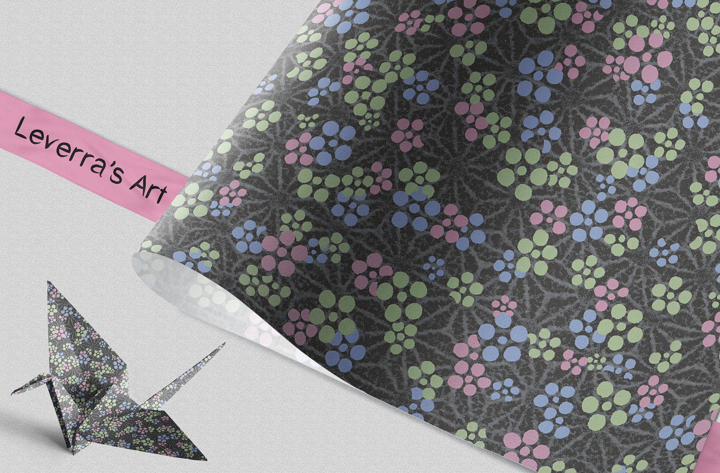 Floral patterned paper with a crumpled effect and an origami crane on a light gray background.