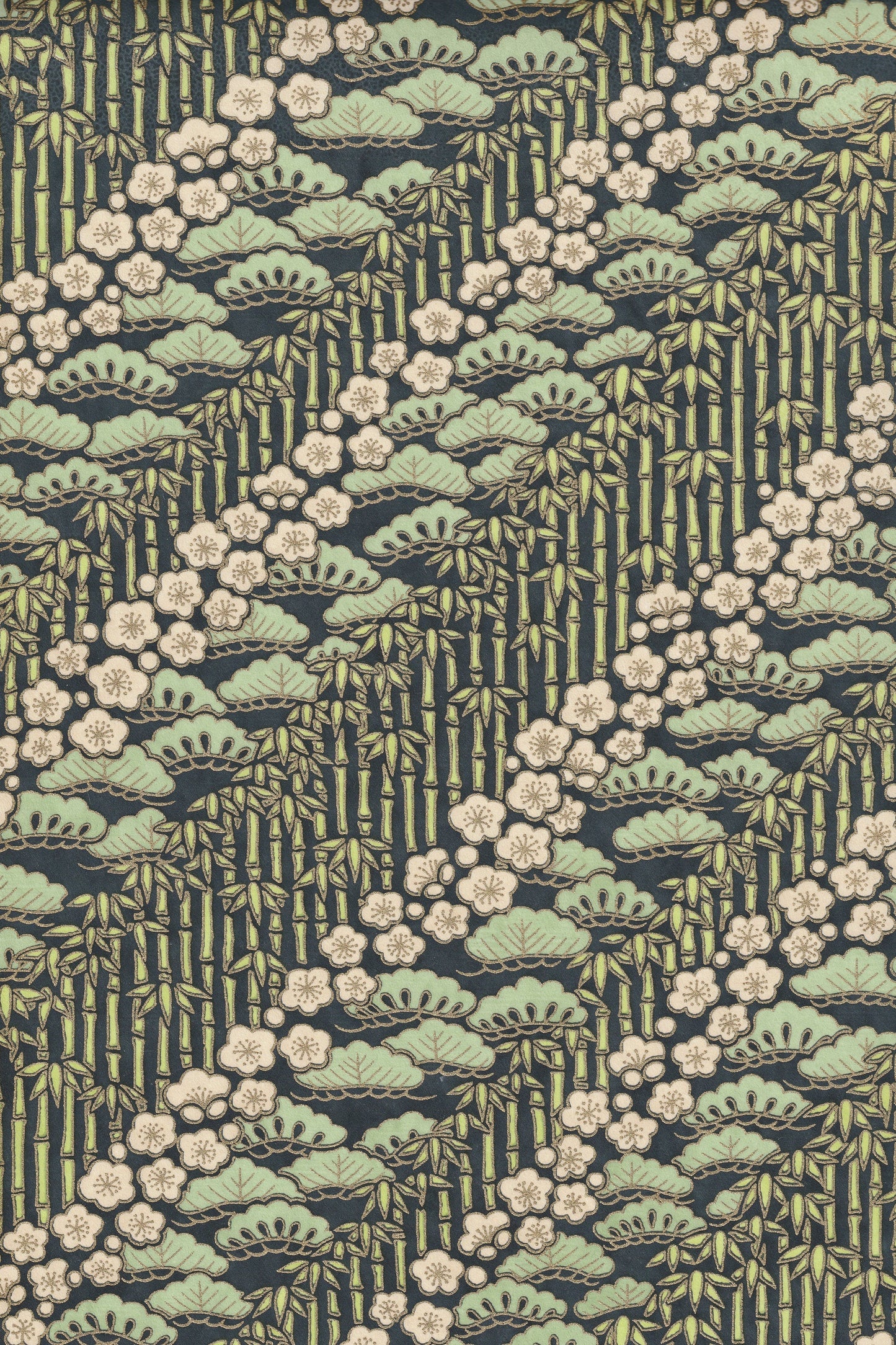 Patterned chiyogami paper with green and beige design on a dark background