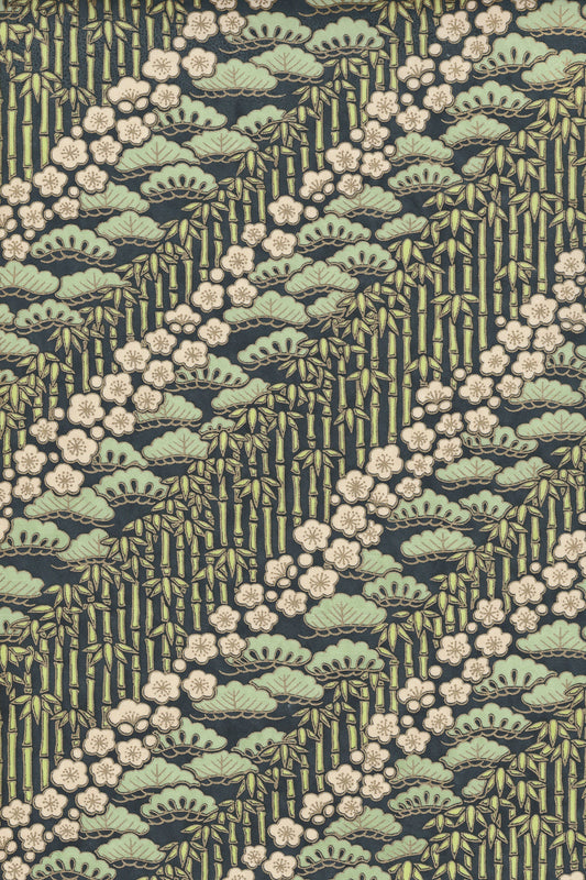Patterned chiyogami paper with green and beige design on a dark background