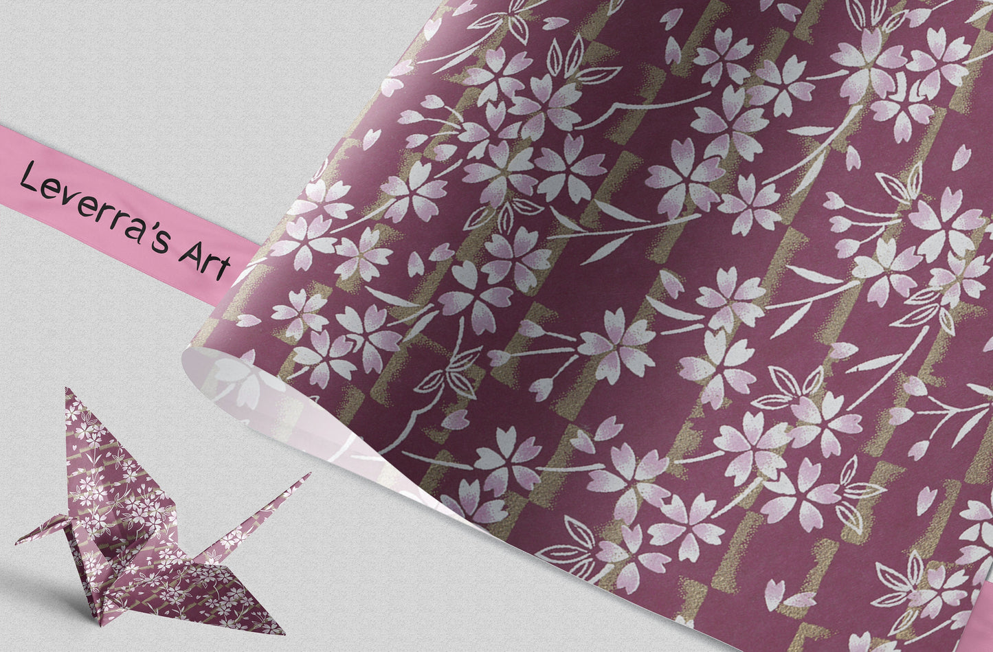 Floral patterned chiyogami paper with a pink ribbon and origami crane on a gray background