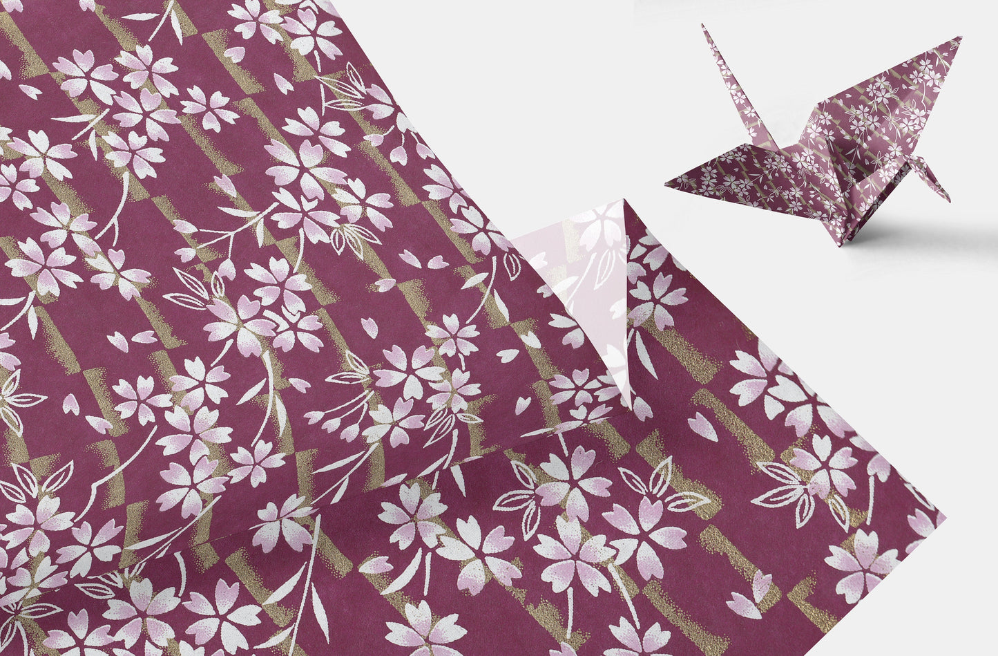 Floral-patterned chiyogami paper with a folded paper crane on a white background