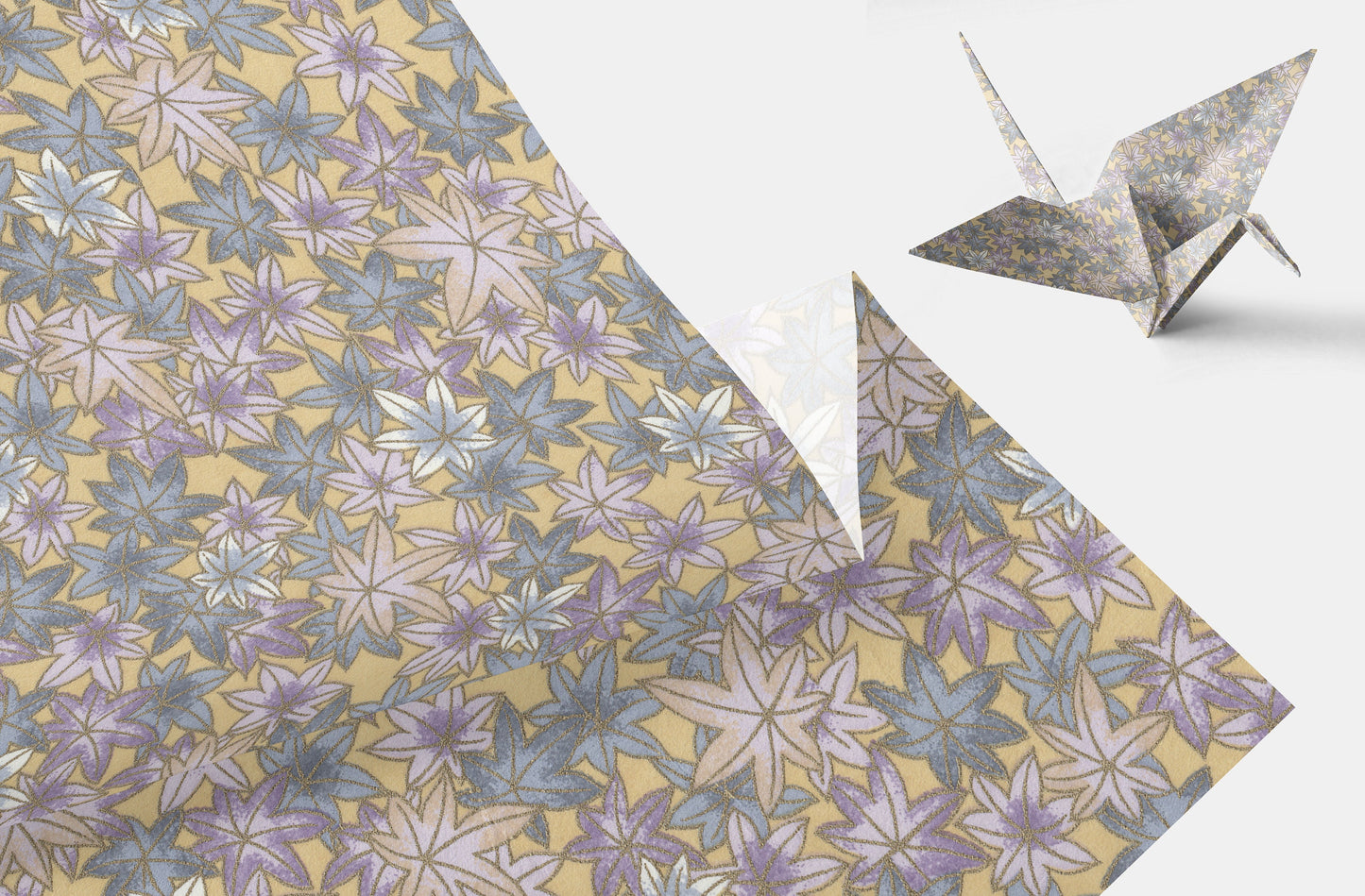Floral-patterned chiyogami paper with a folded paper crane on a white background