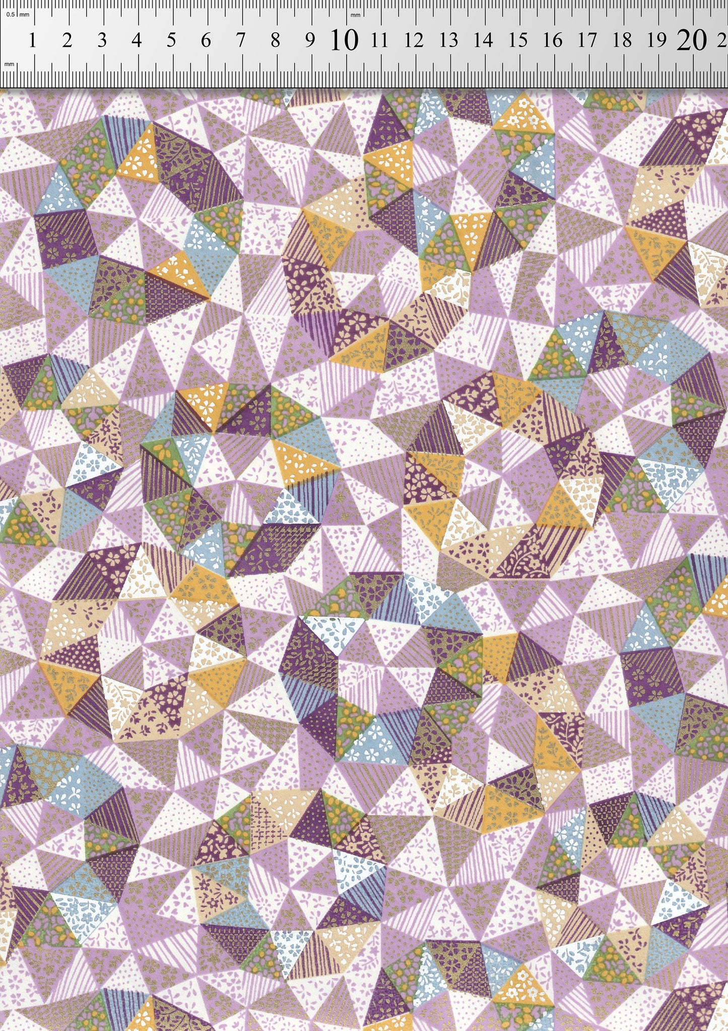 Chiyogami paper with a geometric triangle pattern in various colors on a ruler background