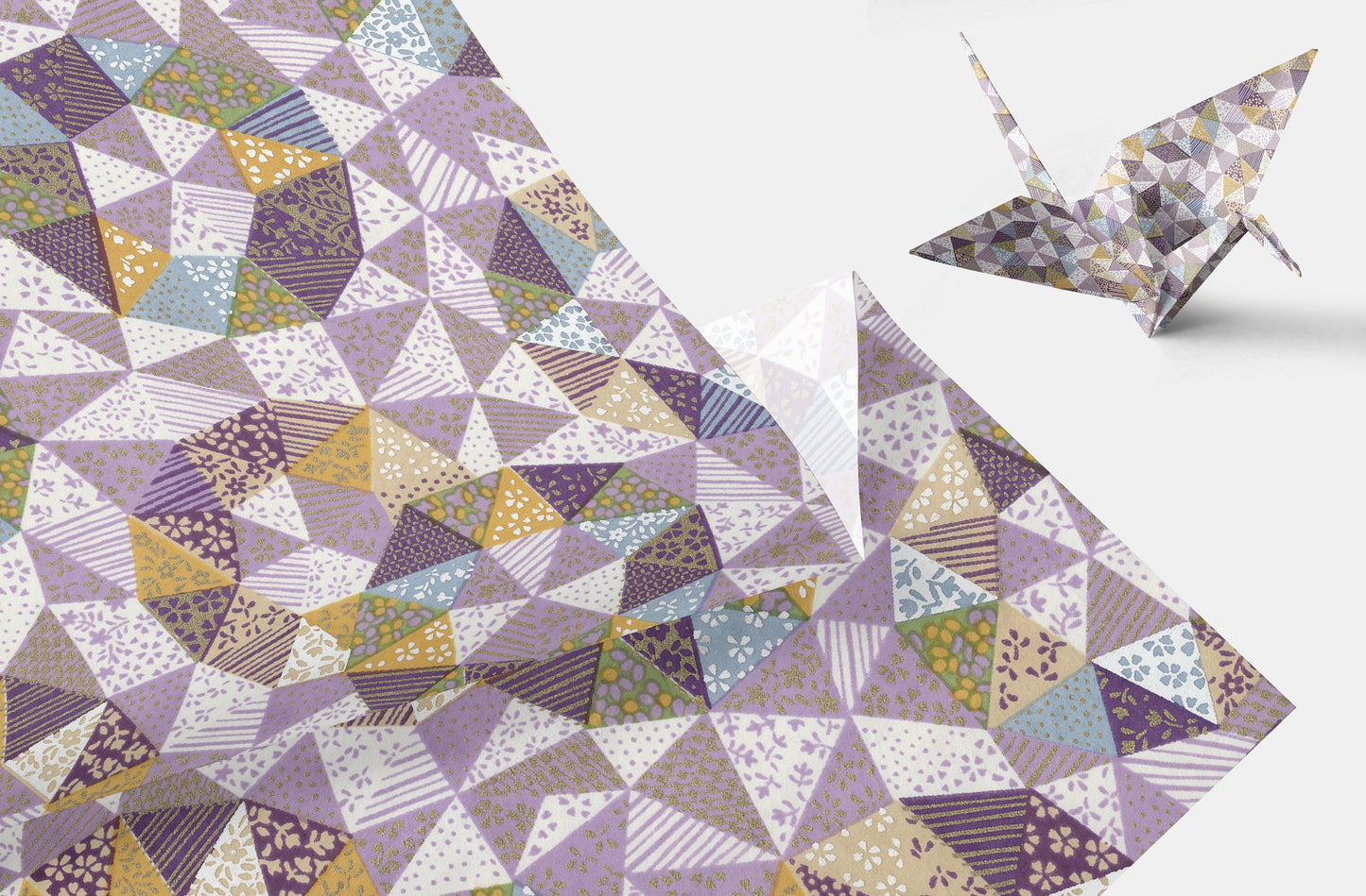 Geometric patterned chiyogami paper with a folded paper crane on a white background