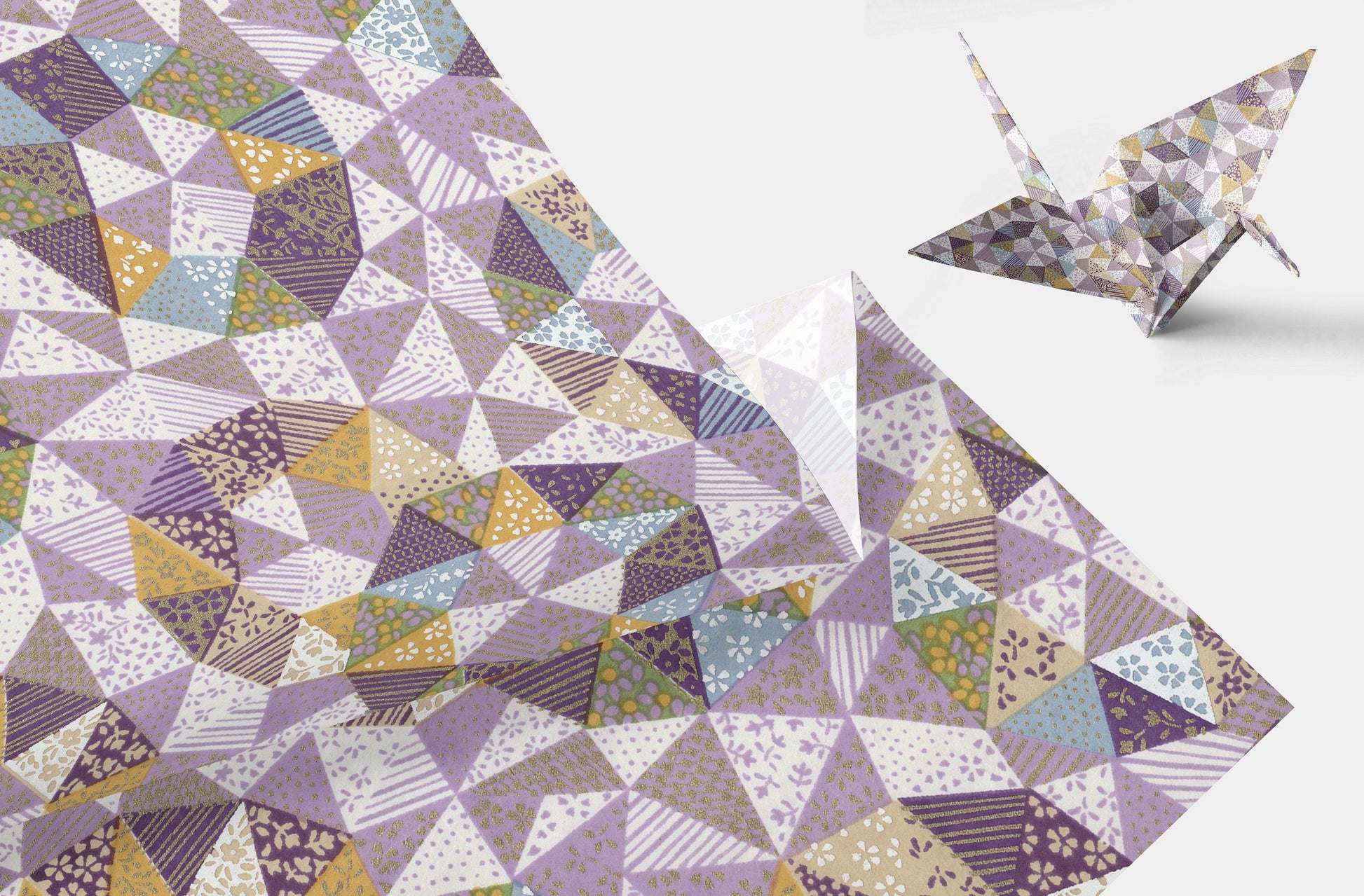 Geometric patterned chiyogami paper with a folded paper crane on a white background
