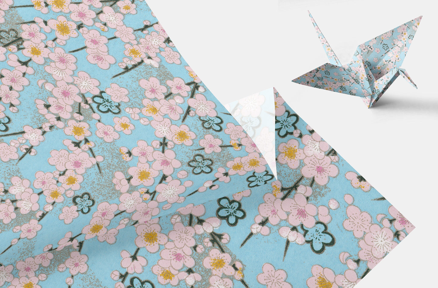 Floral patterned chiyogami paper with a folded paper crane on a white background