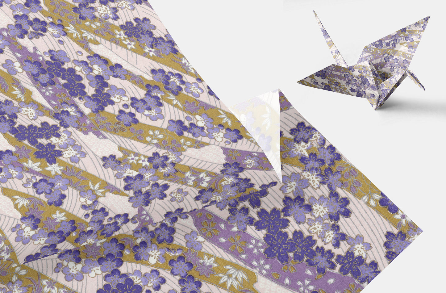 Floral patterned paper with a folded paper crane on a white background