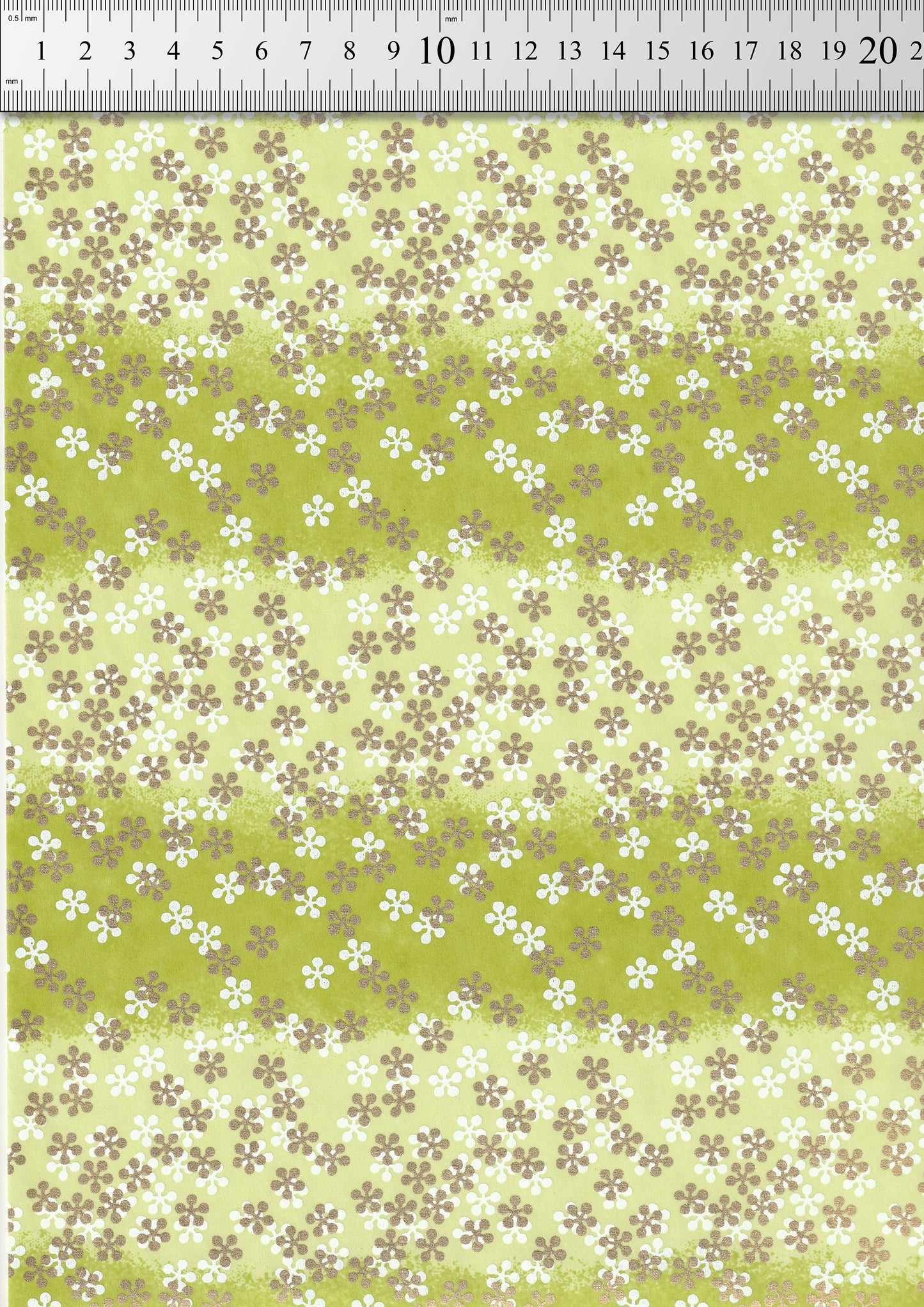 Floral patterned  chiyogami paper with a ruler at the top for scale.