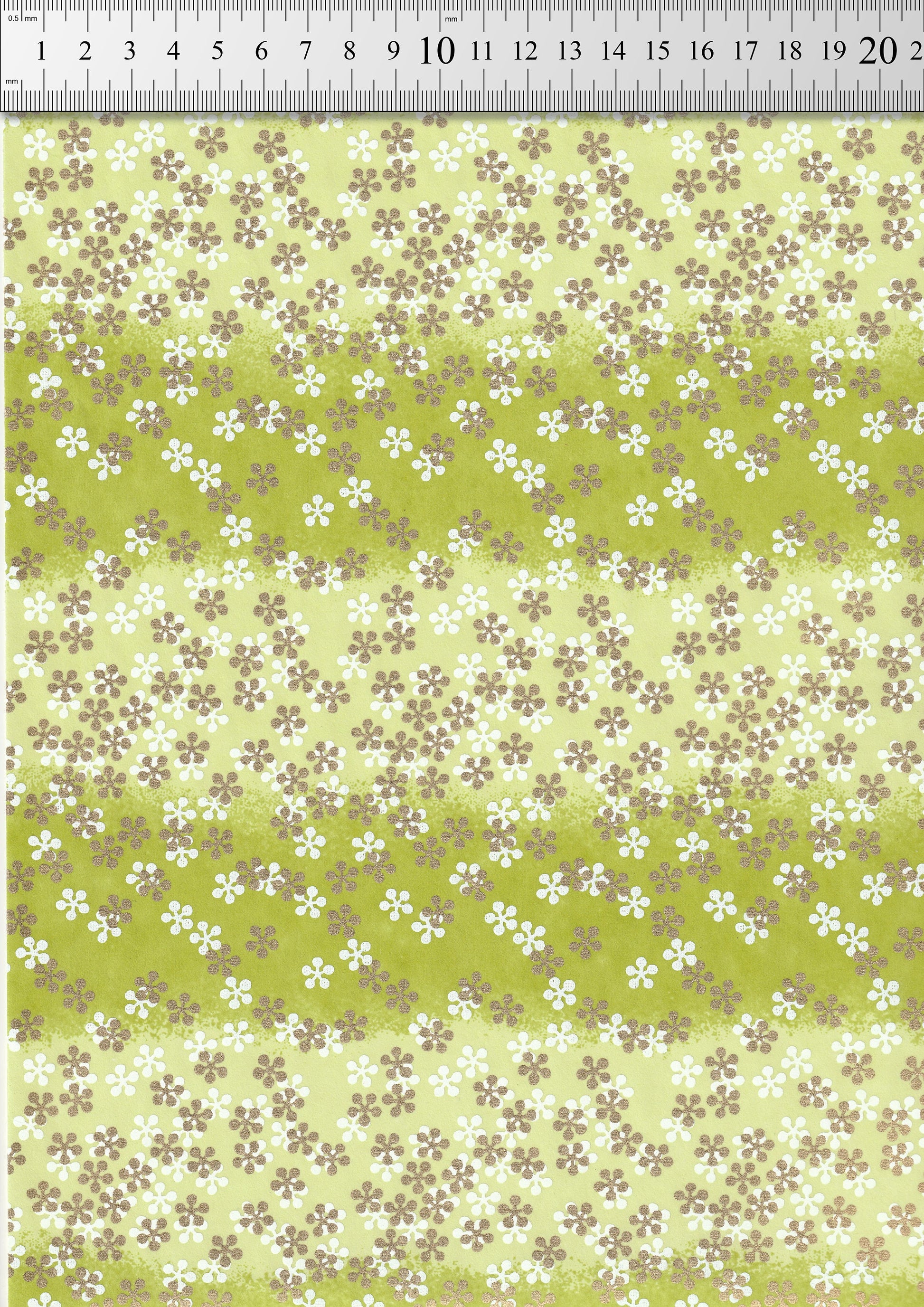 Floral patterned  chiyogami paper with a ruler at the top for scale.