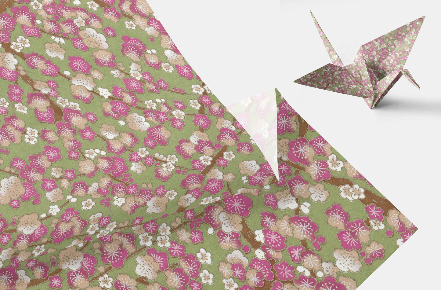 Floral-patterned chiyogami paper with a folded paper crane on a white background