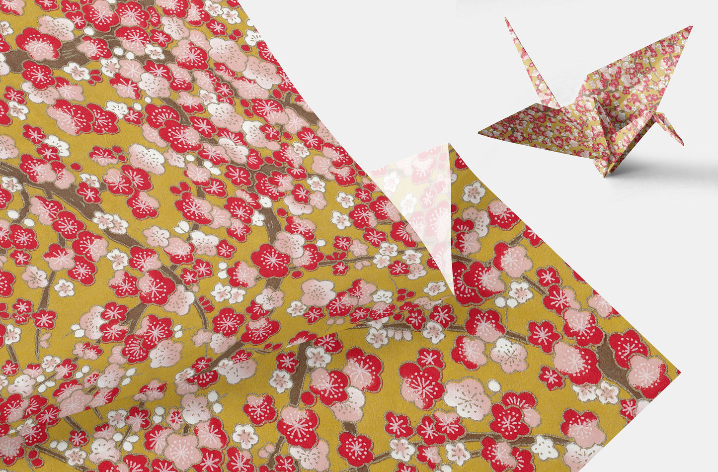 Floral-patterned paper with a folded paper crane on a white background