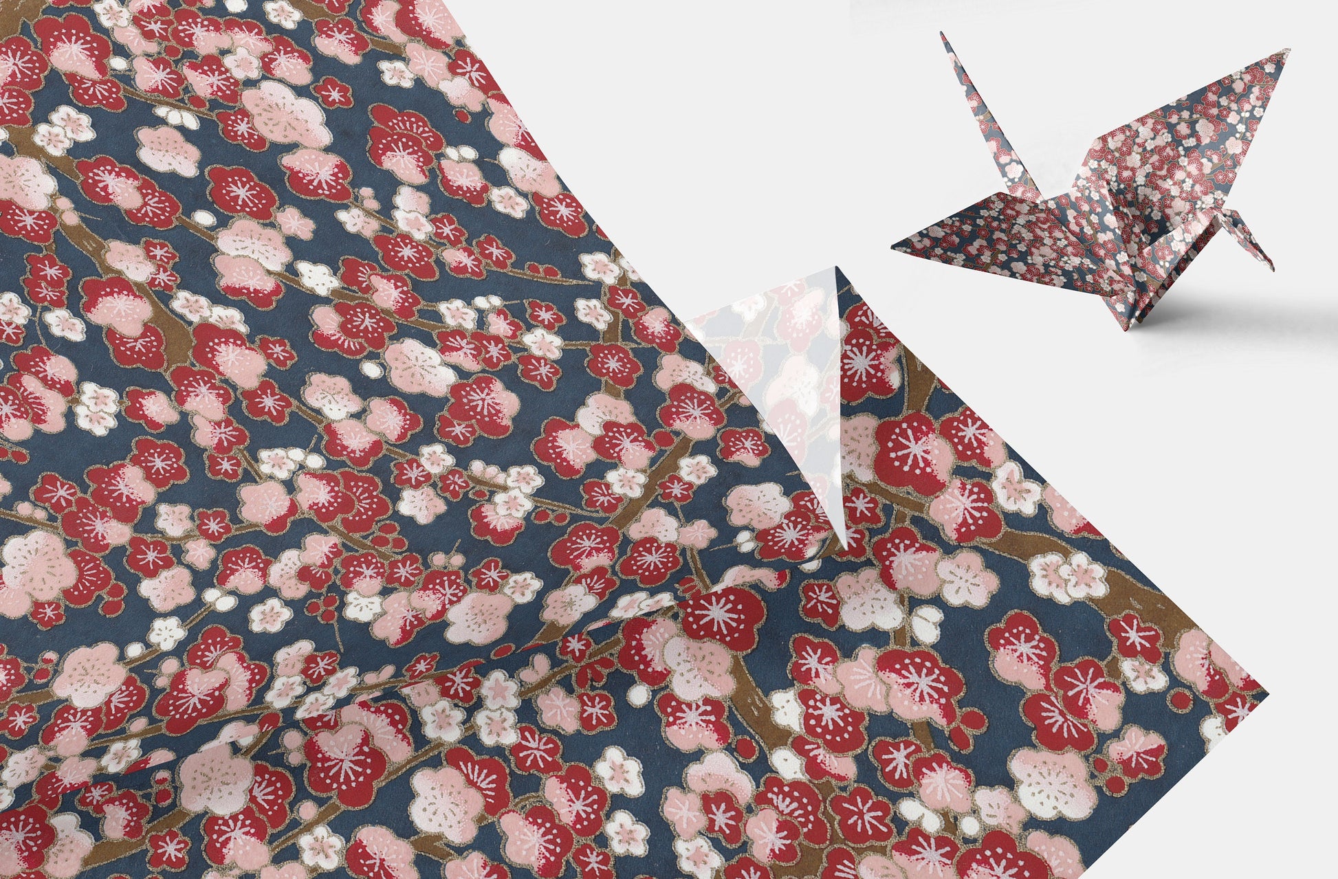 Floral patterned paper with a folded paper crane on a white background