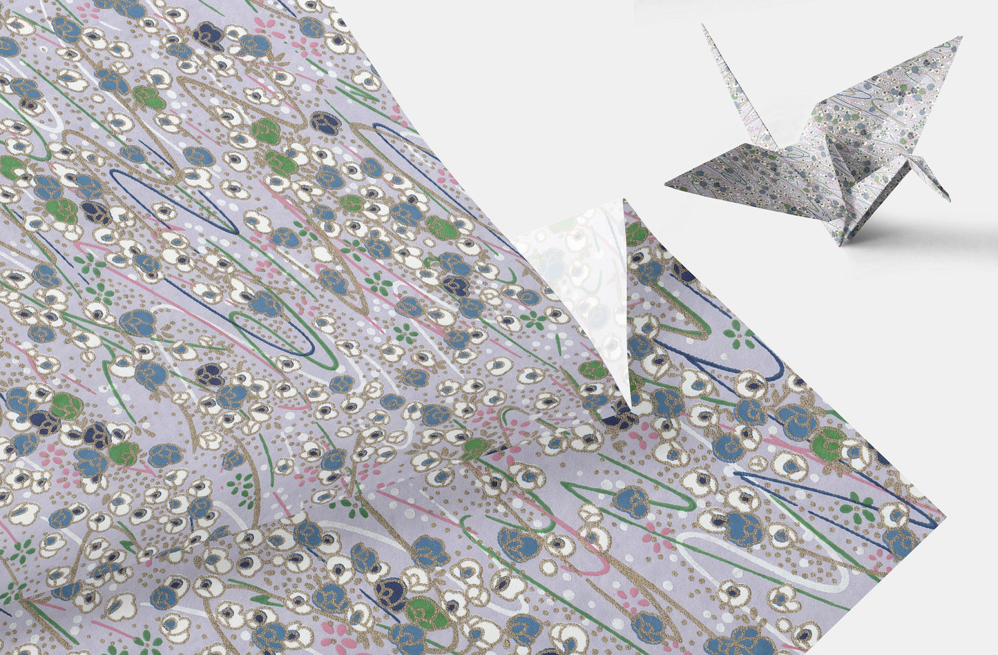Origami crane on a patterned paper background