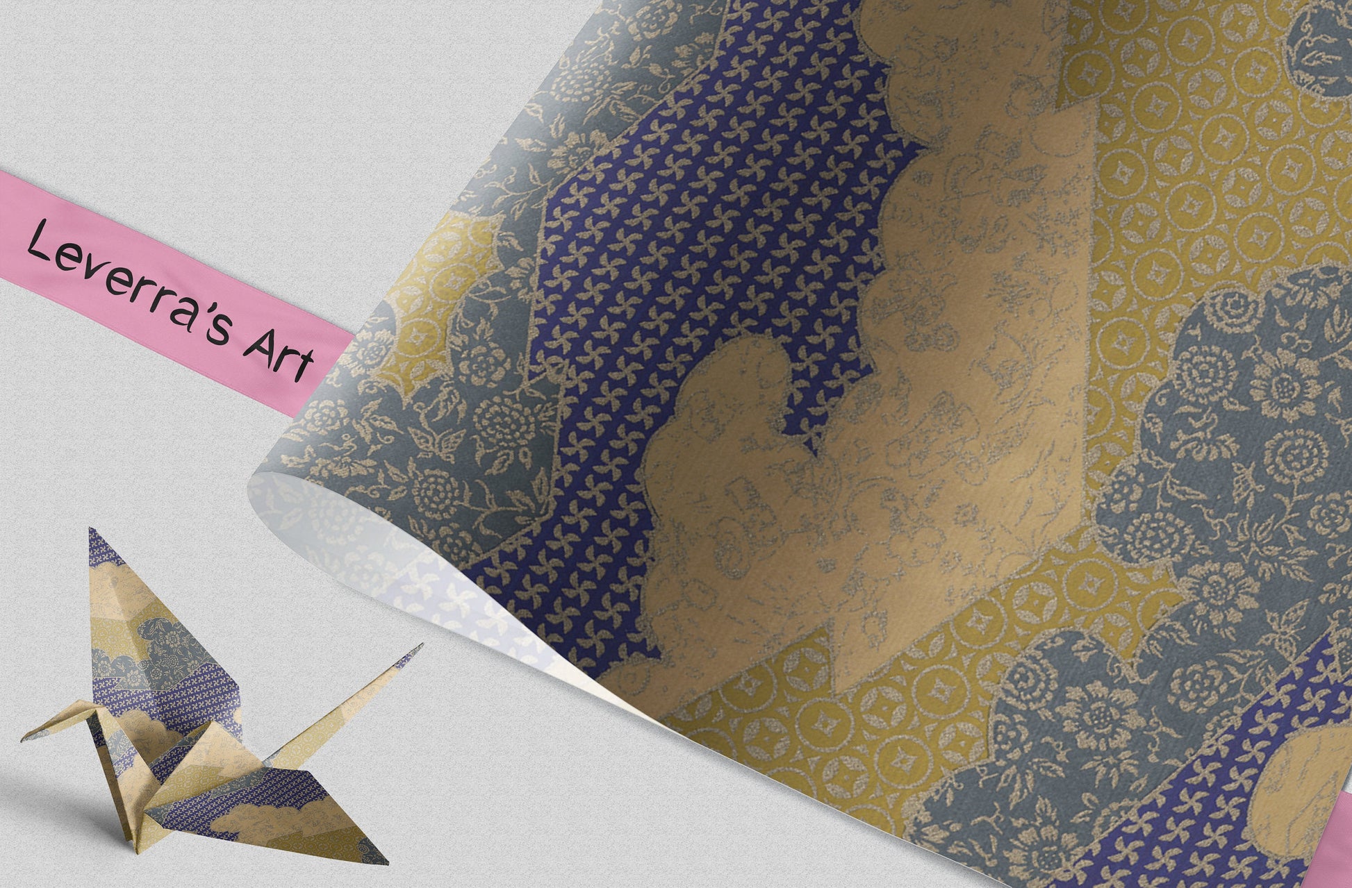 Patterned chiyogami paper with an origami crane and a pink label reading 'Leverra's Art' on a light gray background.