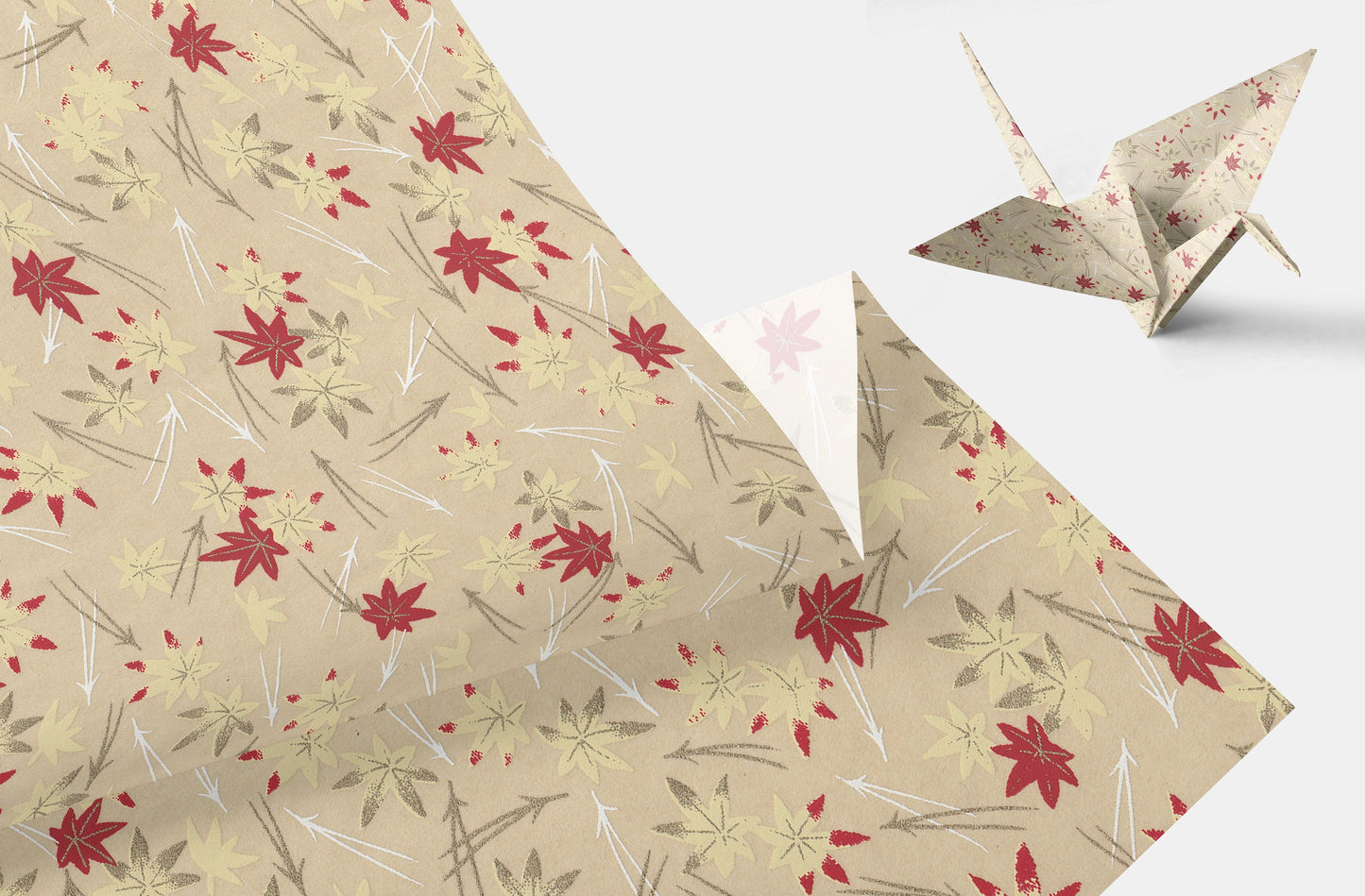 Beige paper with red floral pattern and a folded paper crane on a white background