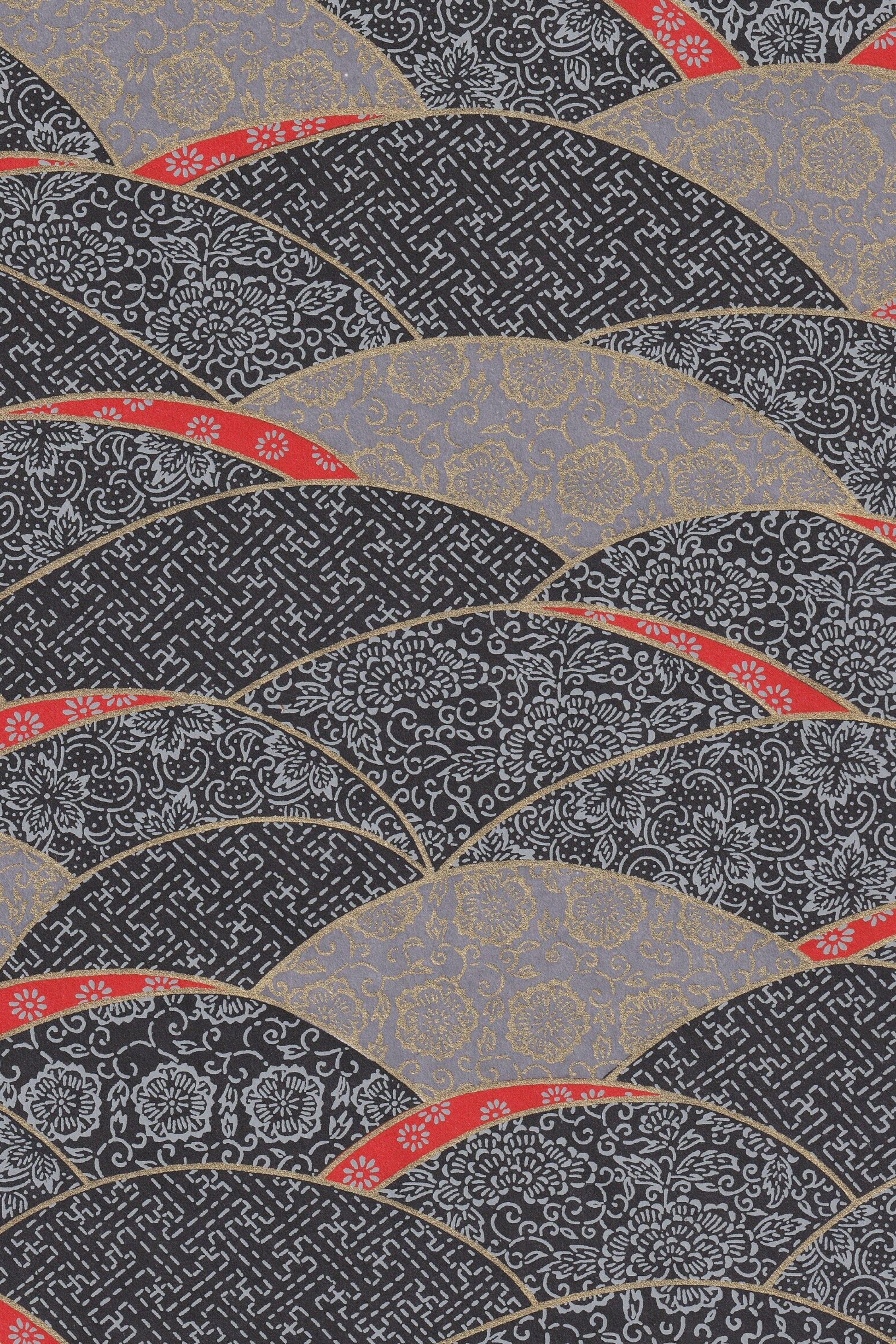 Decorative patterned chiyogami paper  with red, gray, and black colors on a textured background